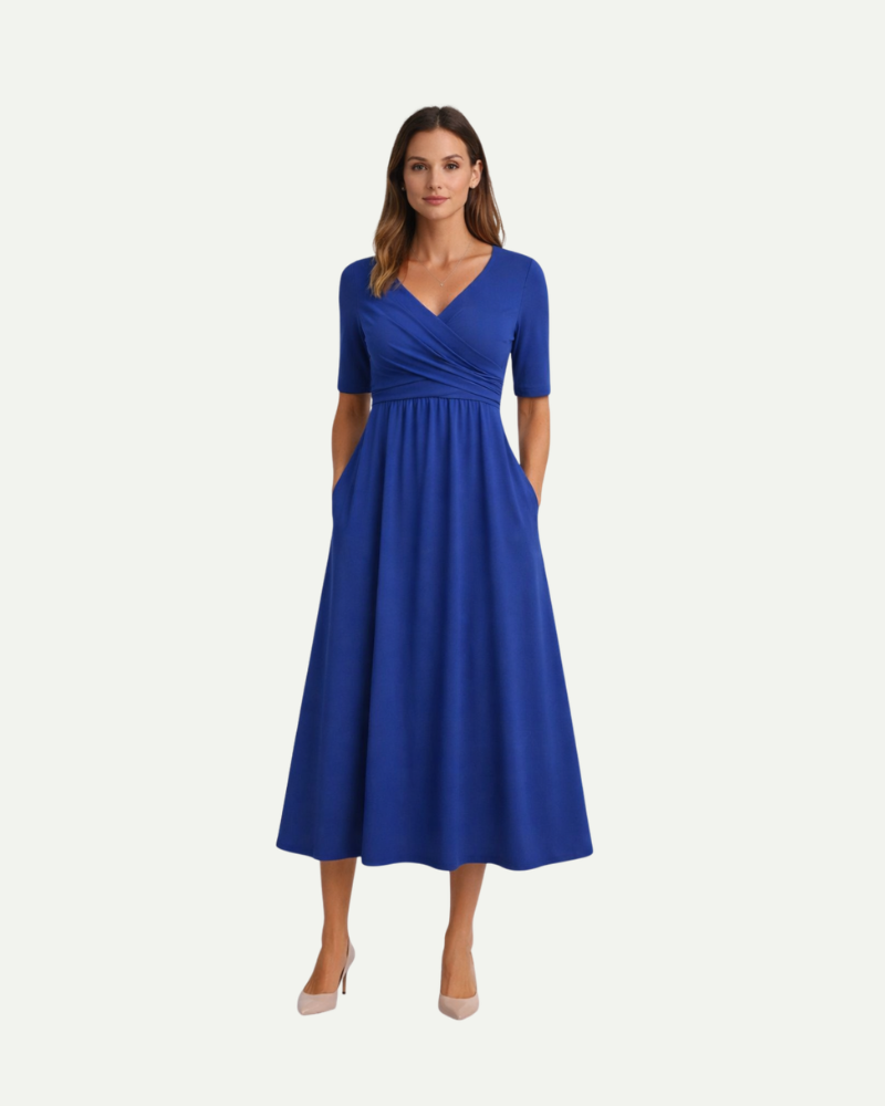 Female model wearing blue V-neck midi dress with short sleeves and flowing silhouette