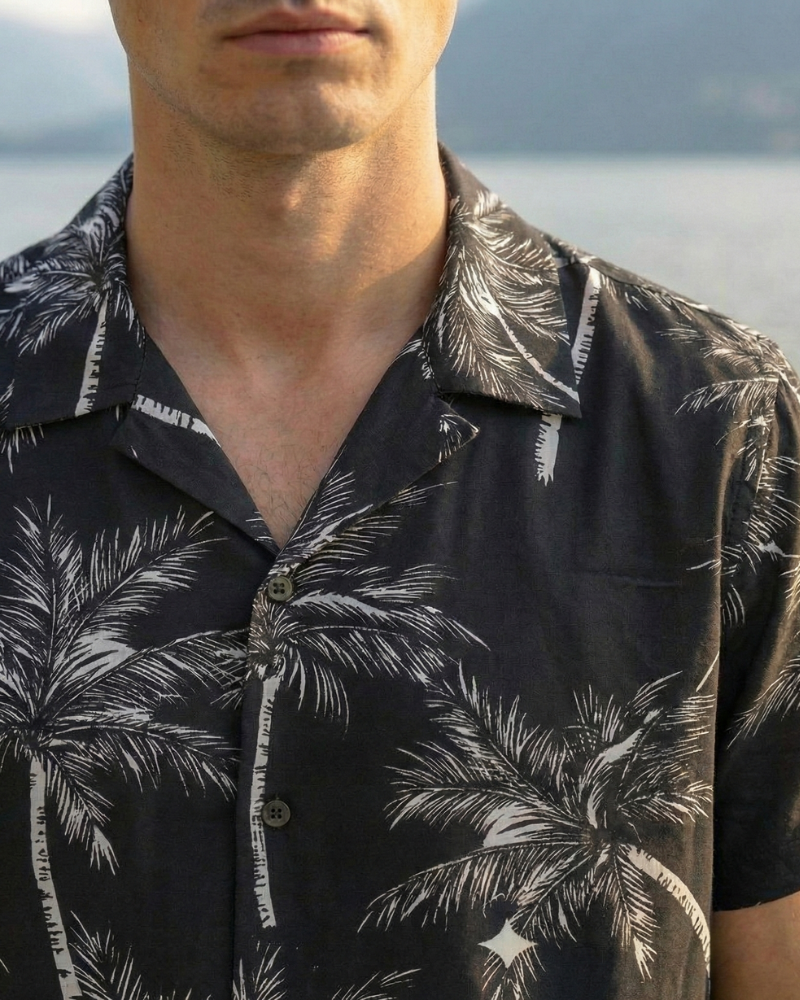 Close-up of black palm print Hawaiian shirt collar and fabric pattern