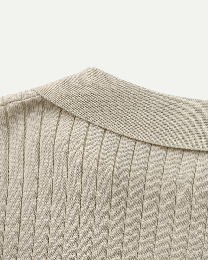 Close-up of a beige ribbed polo collar on a white background