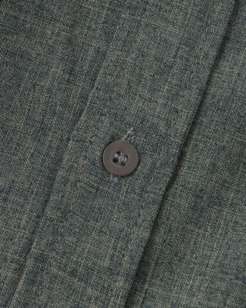 Close-up of a button on a textured fabric