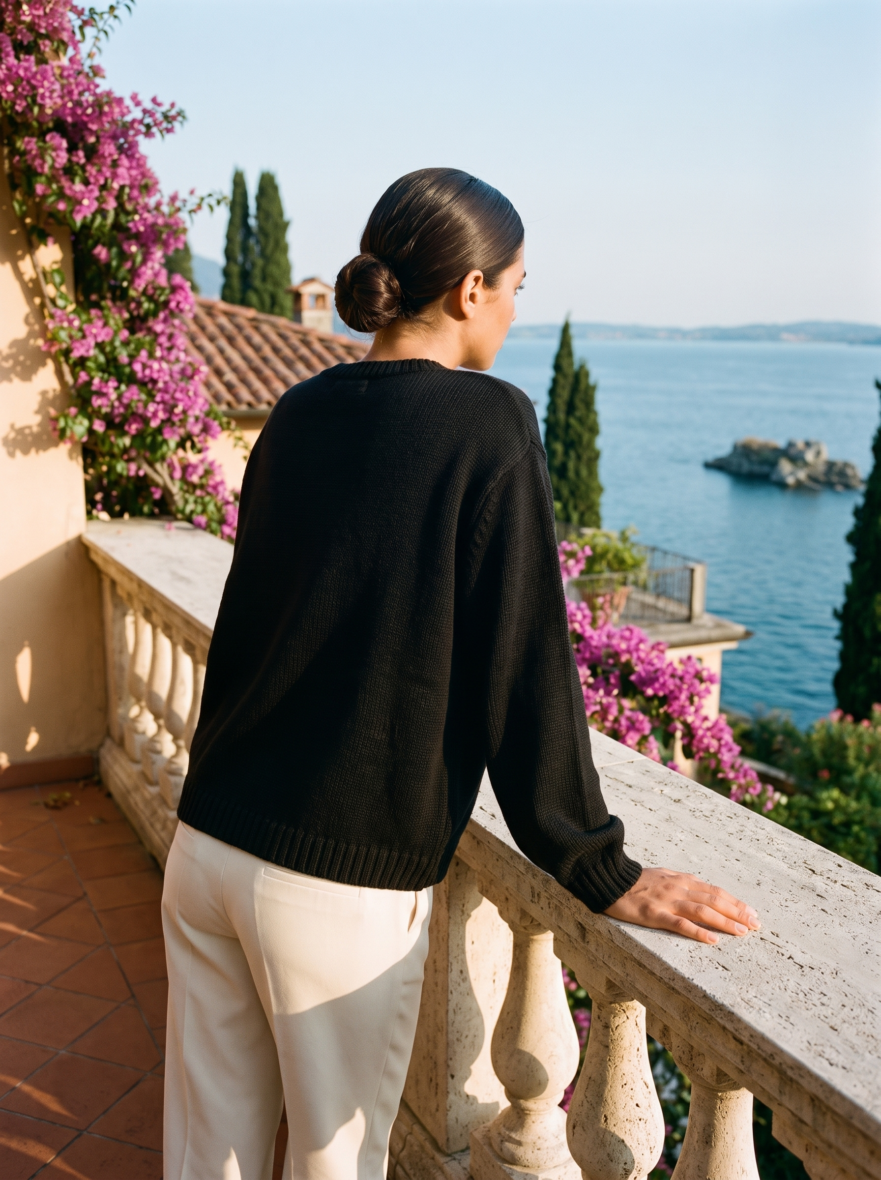 Black button cardigan, full body back view on a Lake Como terrace — Aveloire