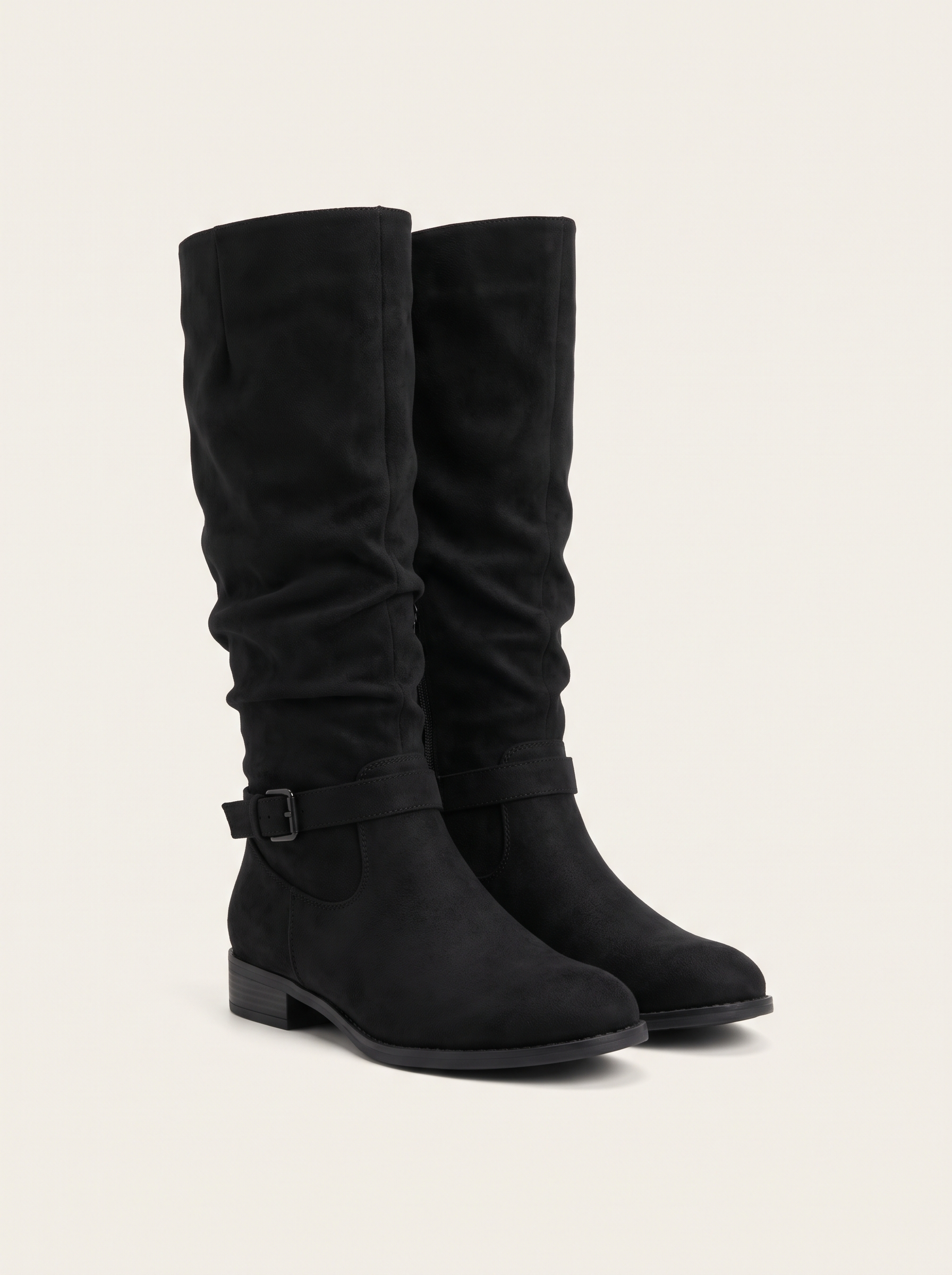 Pair of black suede-look slouch knee high boots on off-white background