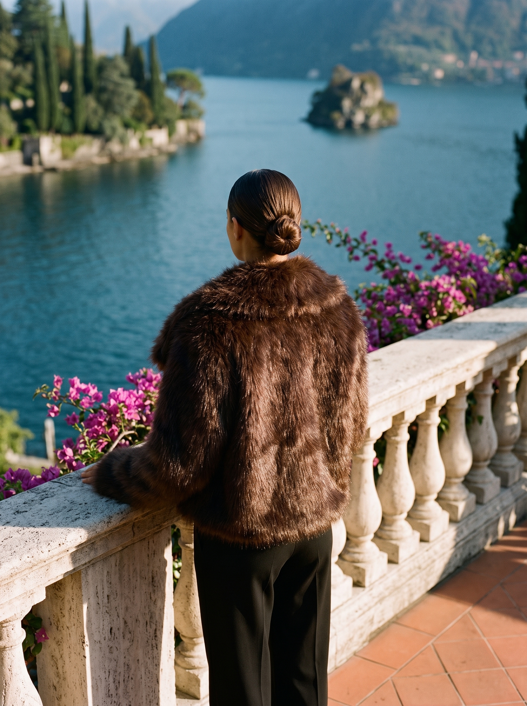 Back view of a brown cropped faux fur coat on a Lake Como terrace — Aveloire