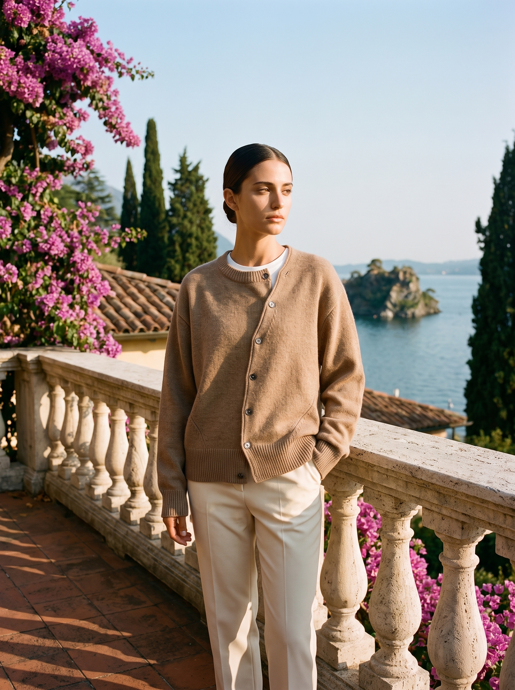 Woman wearing a brown knit cardigan, full body front view on a Lake Como terrace — Aveloire