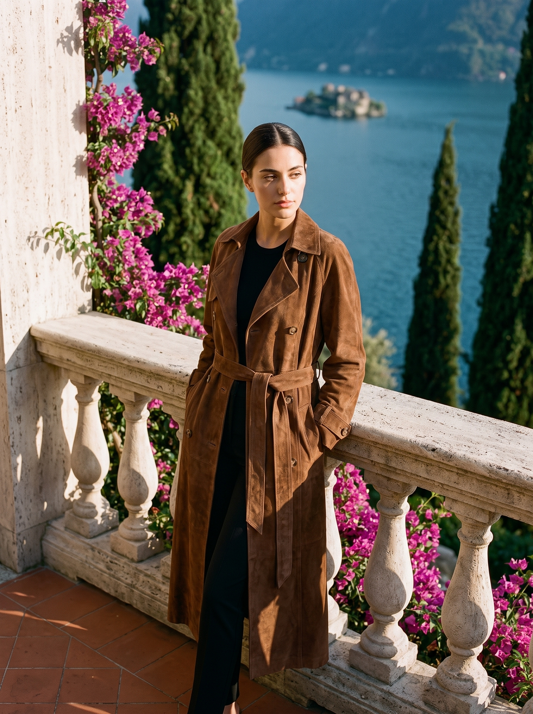 Full-length front view of a brown suede trench coat on a Lake Como terrace — Aveloire