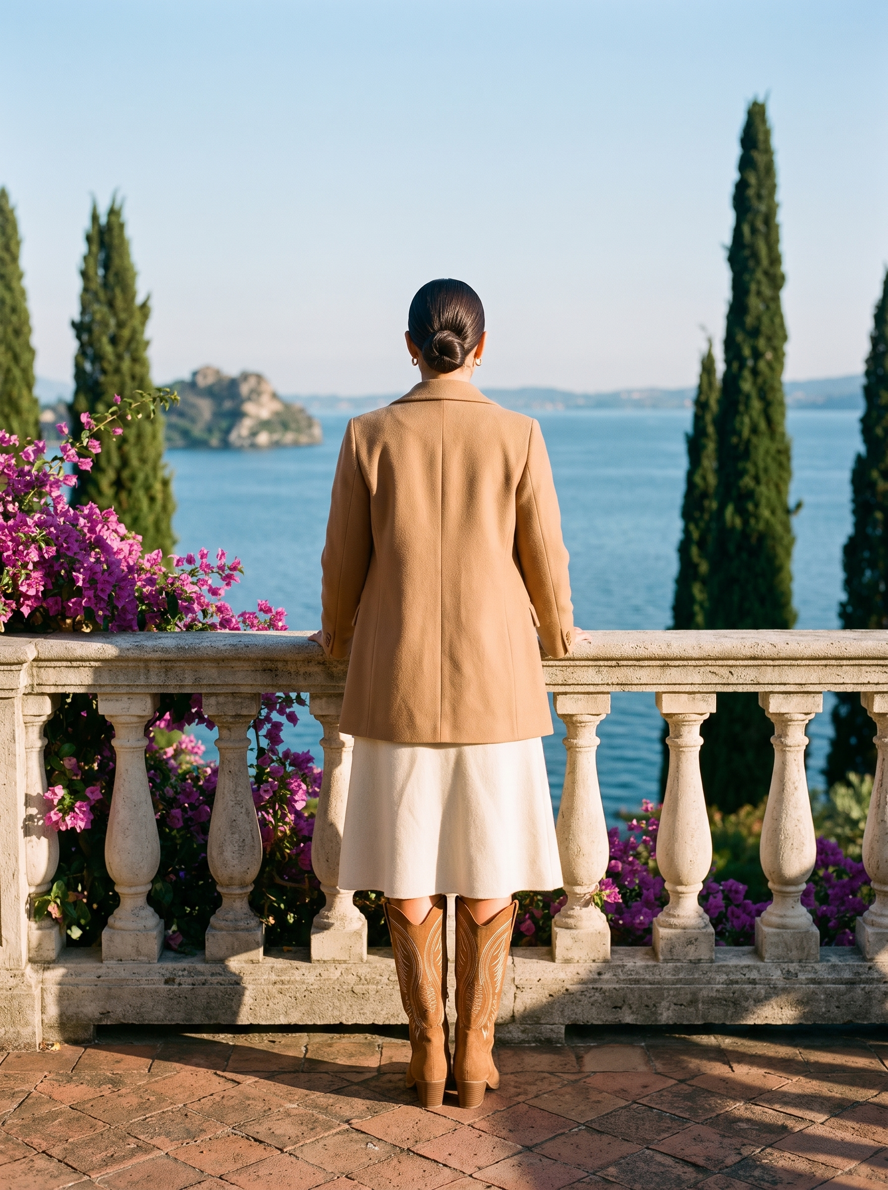 Back view of camel embroidered western knee high boots at a Lake Como balustrade — Aveloire