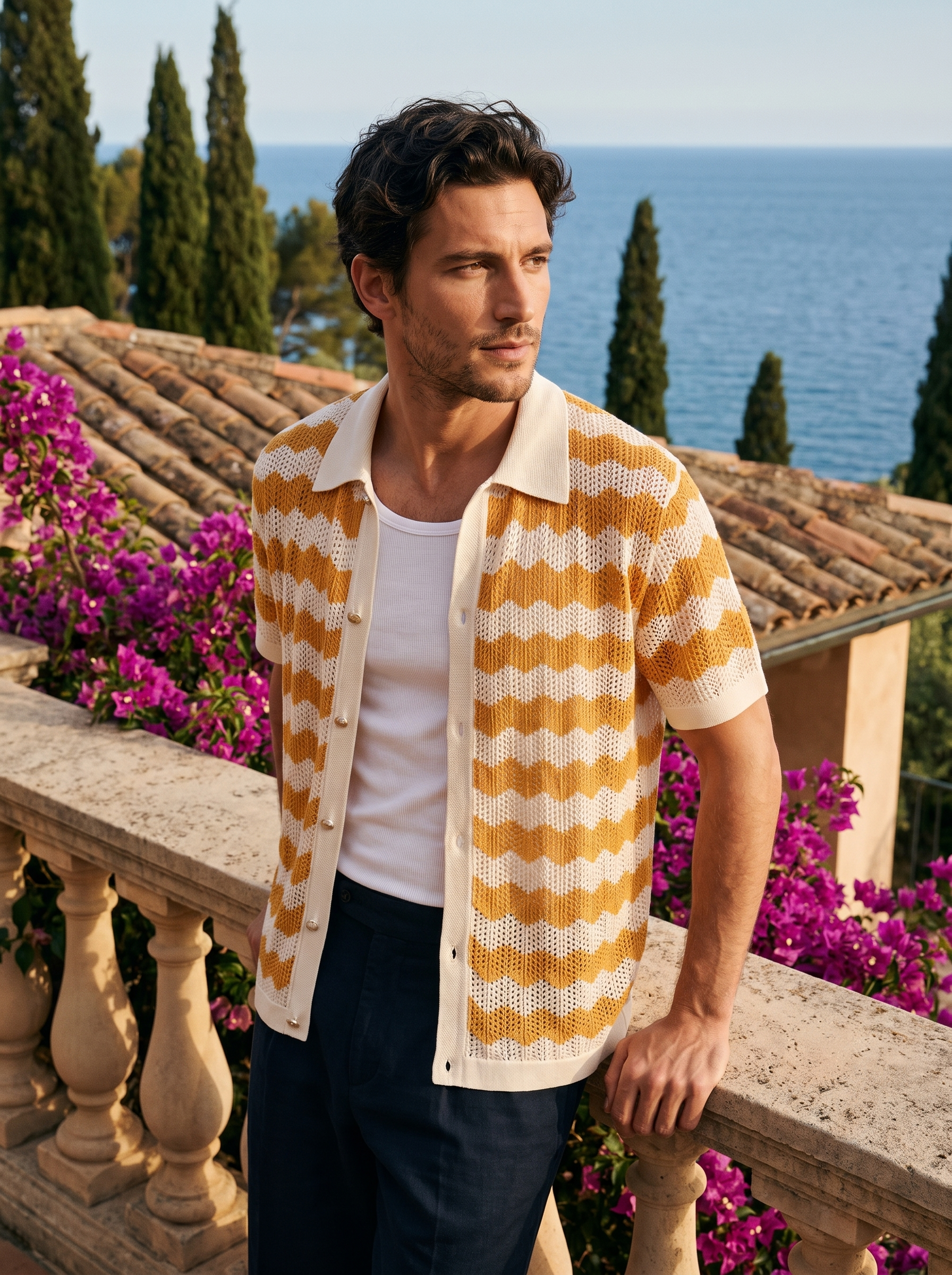 Man wearing a light orange and cream wave knit button shirt on a balcony overlooking Lake Como, old money style — Aveloire