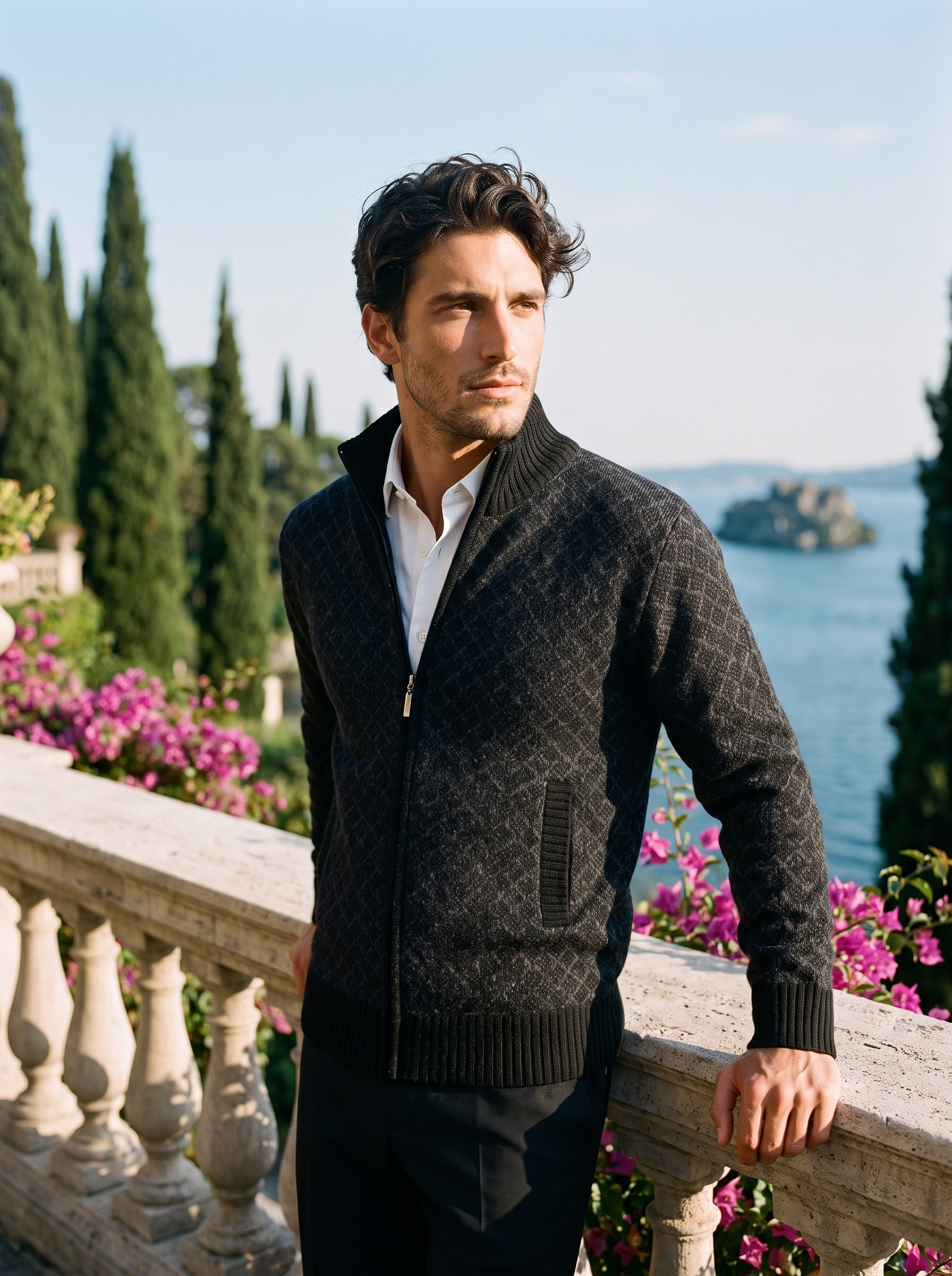 Man wearing a black full-zip stand collar cardigan on a terrace overlooking Lake Como, old money style — Aveloire
