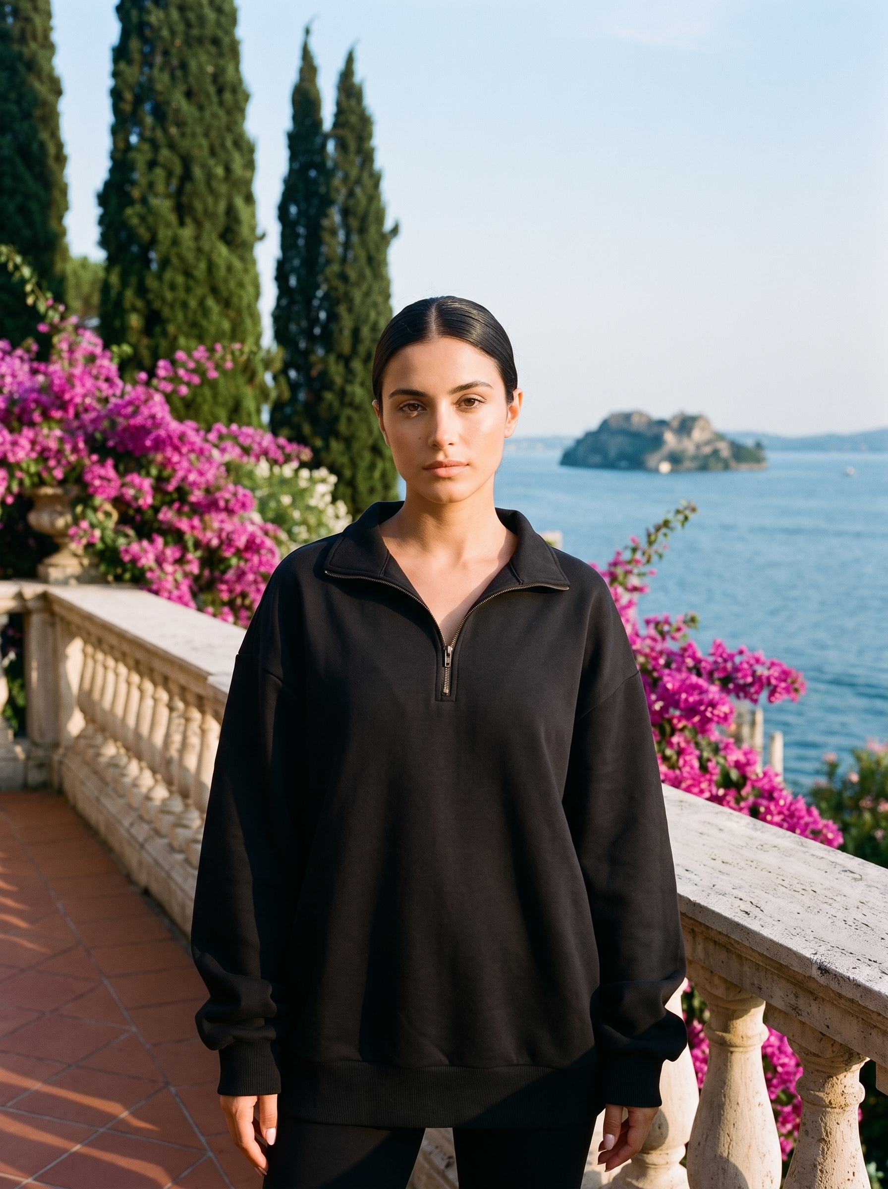 Woman wearing a black half-zip oversized sweatshirt on a Lake Como terrace — Aveloire