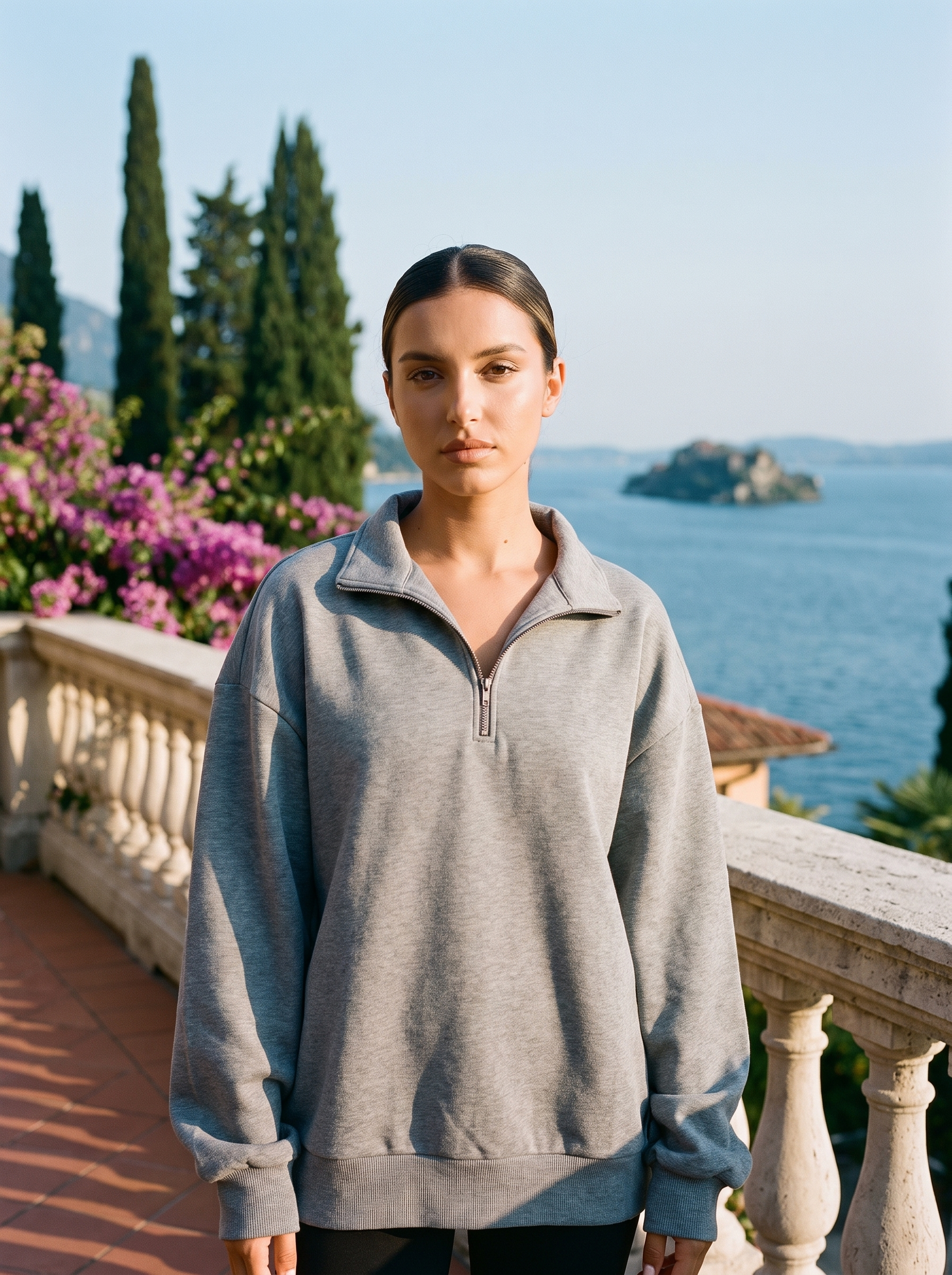 Woman wearing a heather gray half-zip oversized sweatshirt on a Lake Como terrace — Aveloire