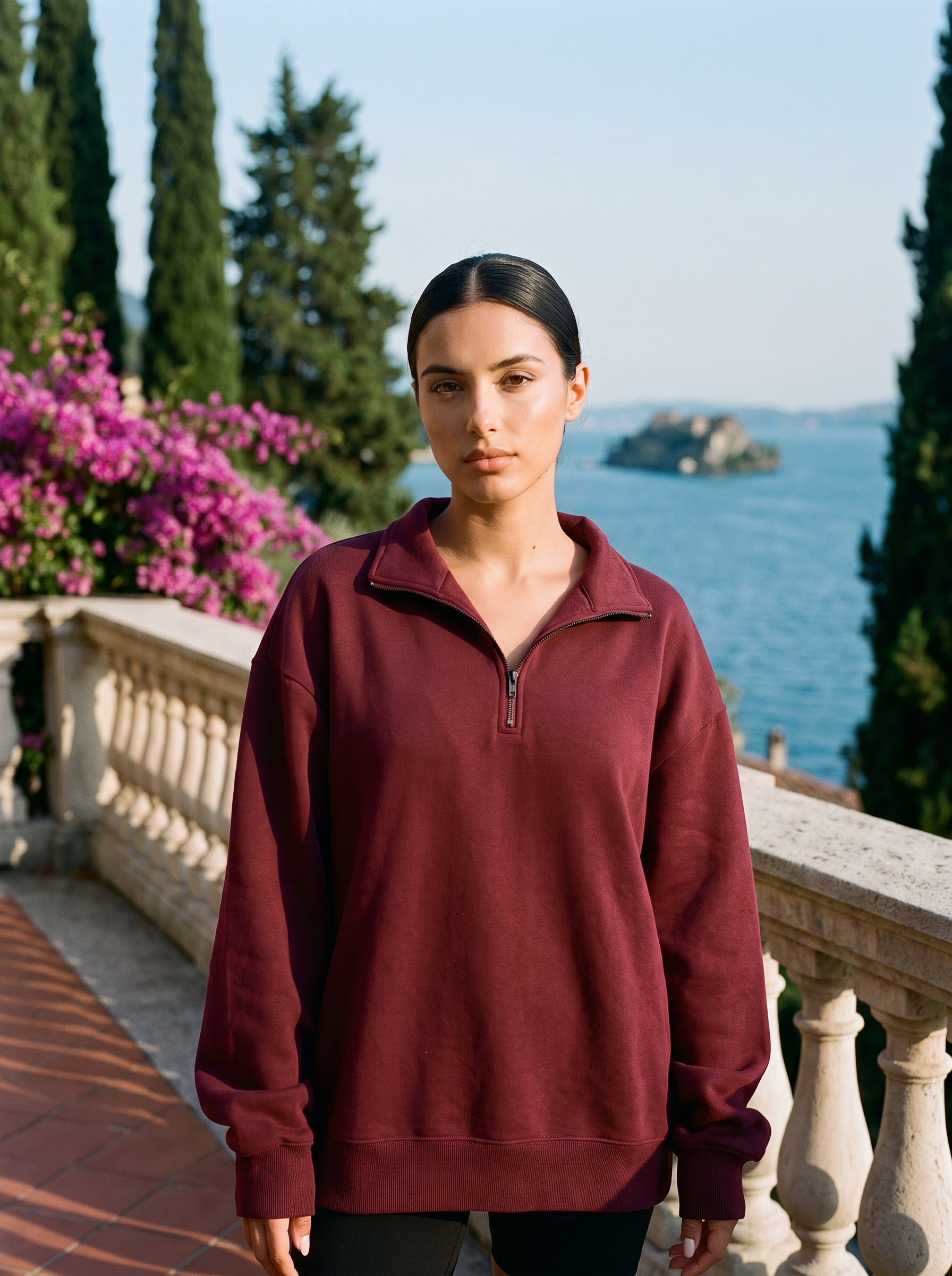 Woman wearing a burgundy half-zip oversized sweatshirt on a Lake Como terrace — Aveloire