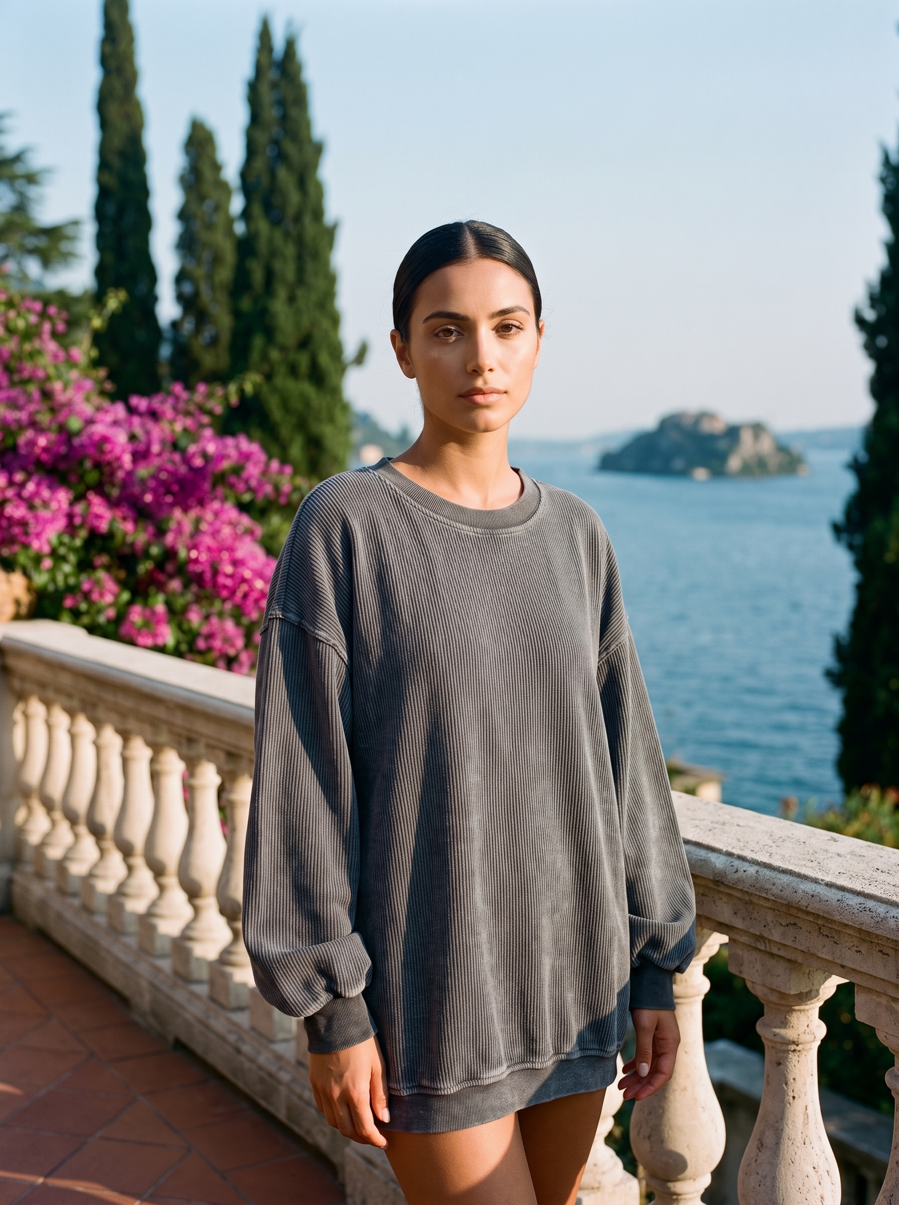 Woman wearing a washed charcoal gray corded oversized sweatshirt on a Lake Como terrace — Aveloire