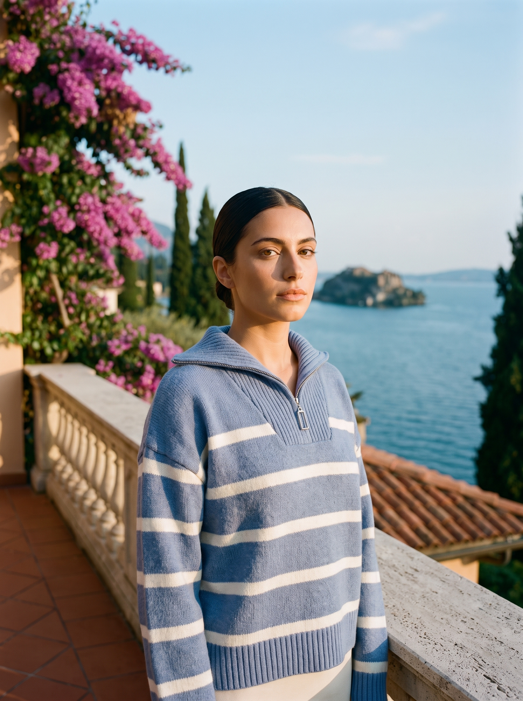 Woman wearing a blue and cream striped quarter-zip polo sweater on a Lake Como terrace — Aveloire