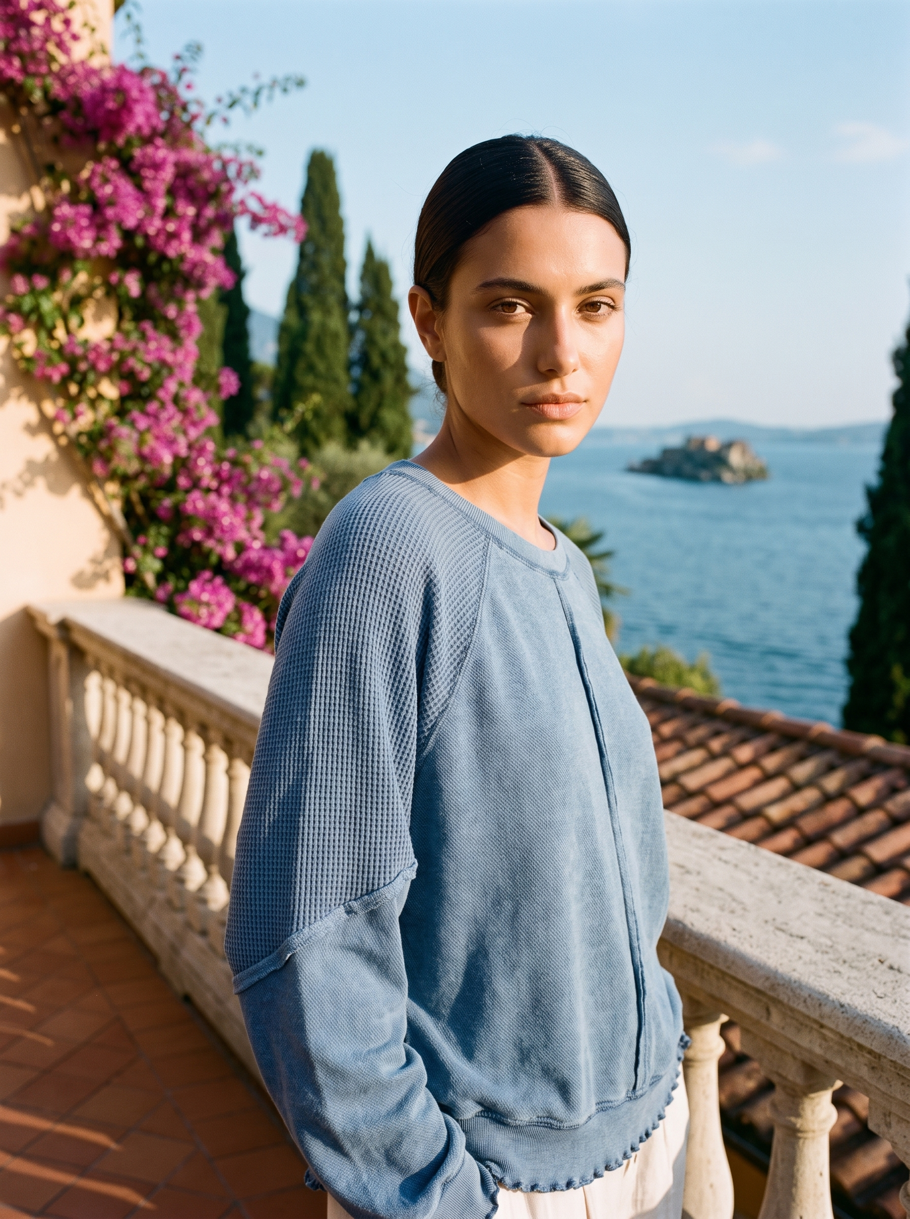 Woman wearing a powder blue waffle-panel top on a Lake Como terrace — Aveloire