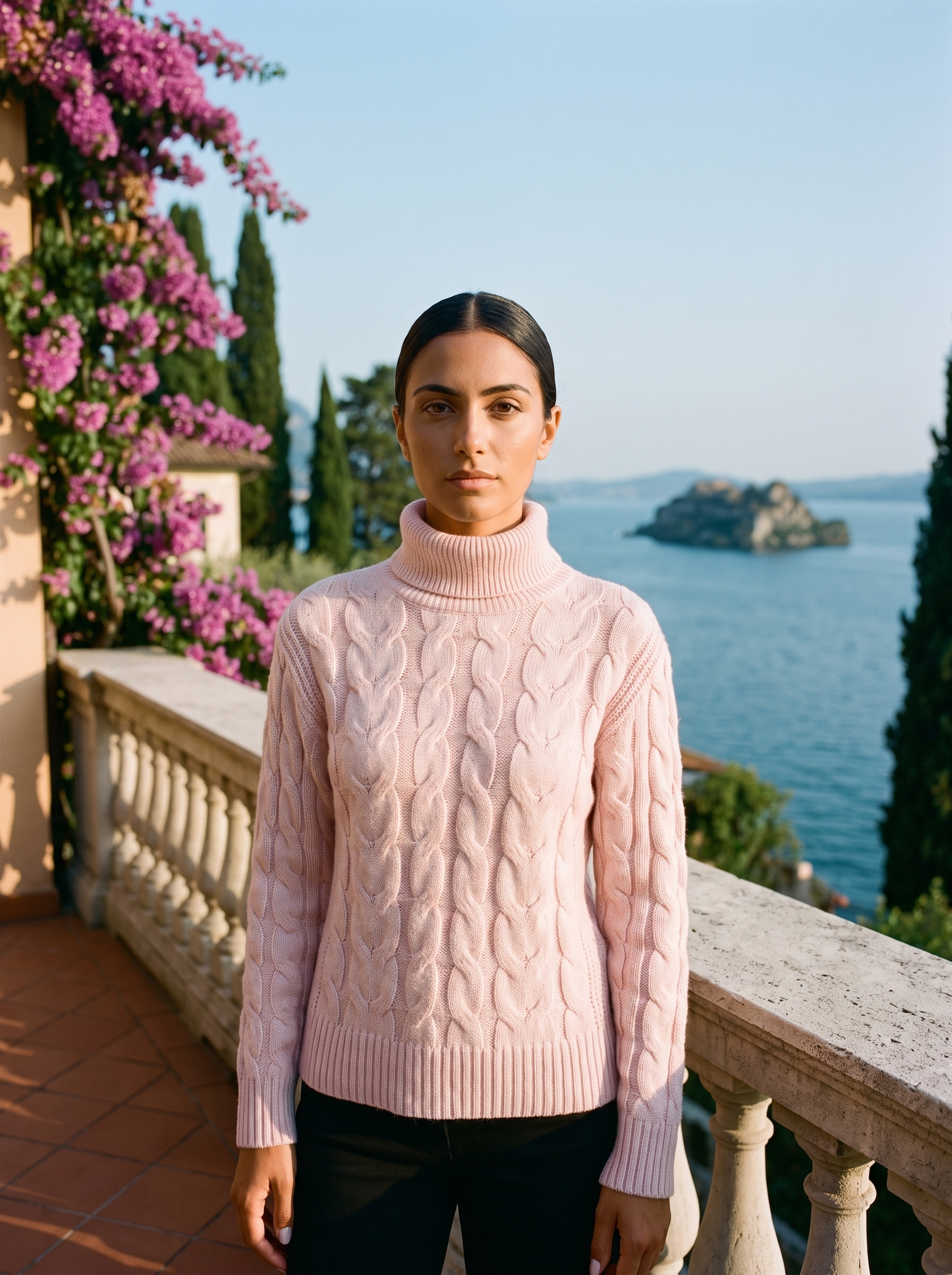 Woman wearing a blush pink cable-knit turtleneck sweater on a Lake Como terrace — Aveloire
