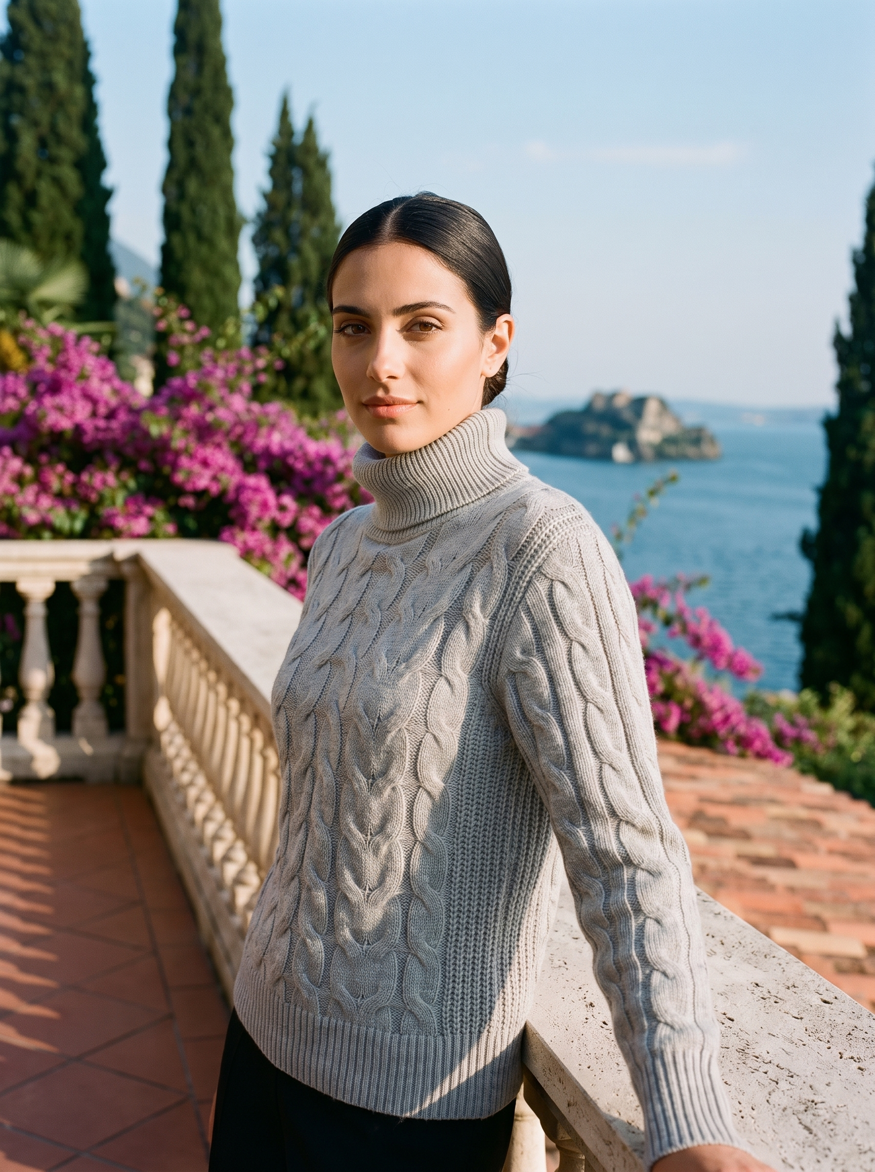 Woman wearing a heather gray cable-knit turtleneck sweater on a Lake Como terrace — Aveloire