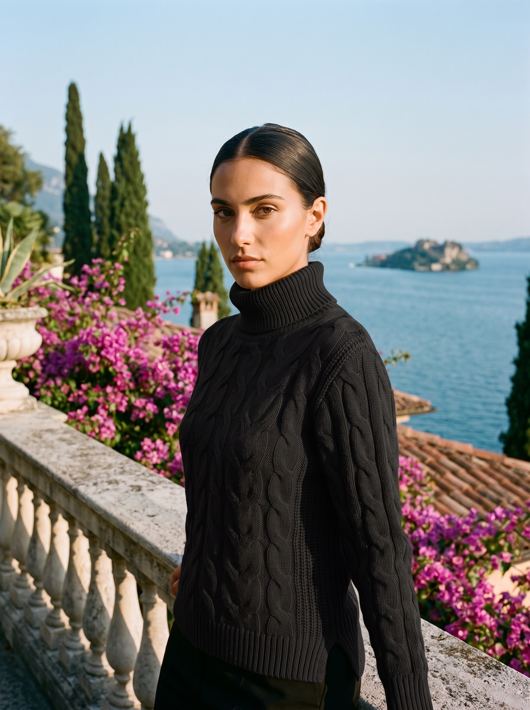 Woman wearing a black cable-knit turtleneck sweater on a Lake Como terrace — Aveloire