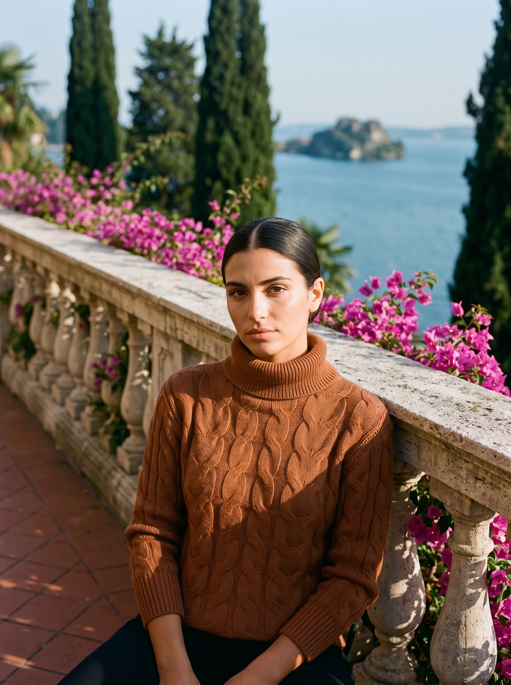 Woman wearing a cinnamon brown cable-knit turtleneck sweater on a Lake Como terrace — Aveloire