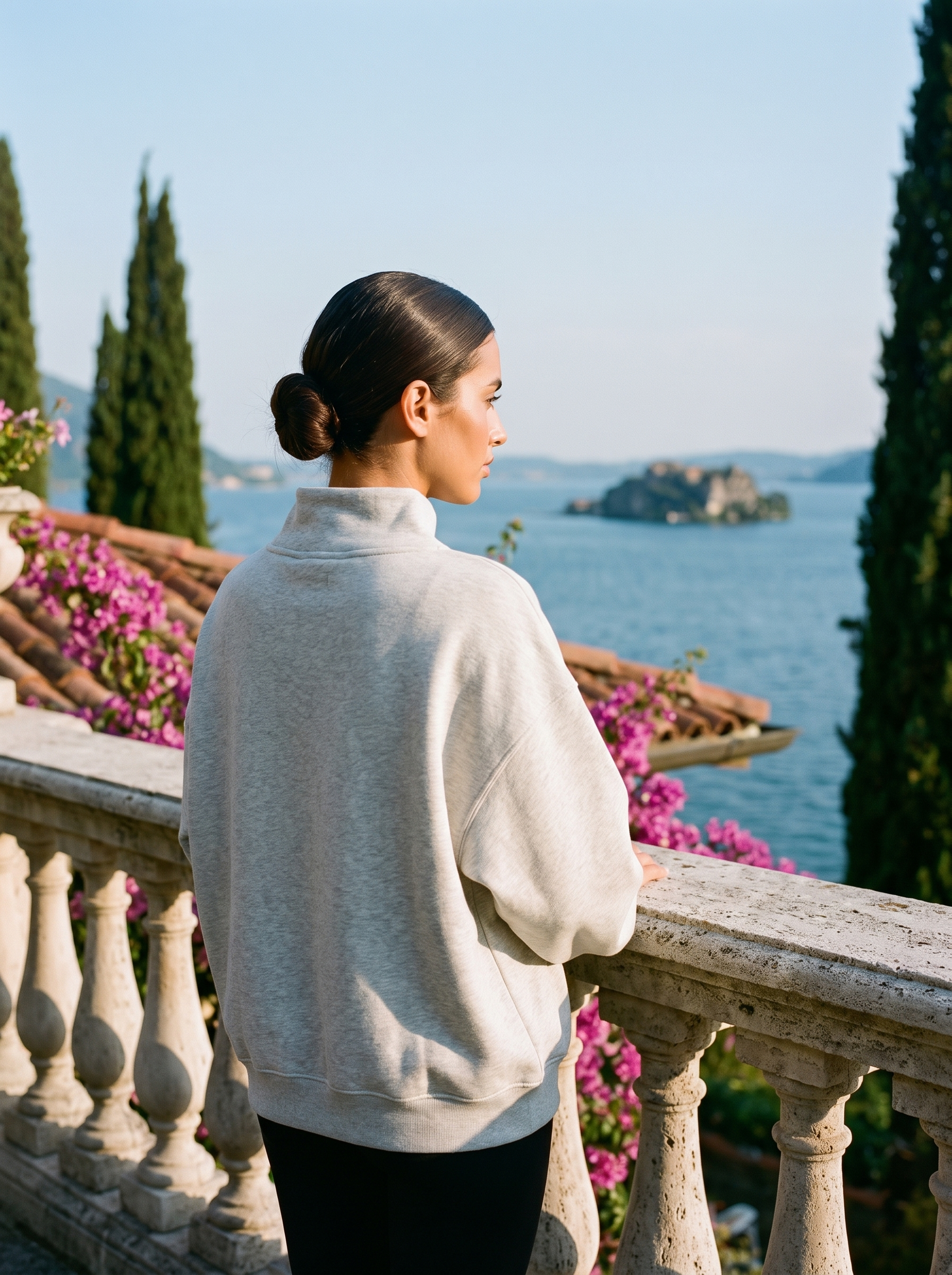 Back view of a light gray oversized turtleneck sweatshirt on a Lake Como terrace — Aveloire