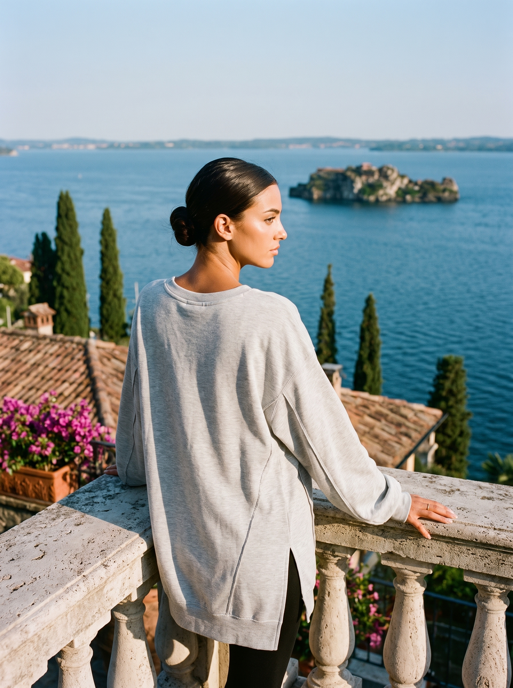 Back view of a light grey V-neck sweatshirt tunic on a Lake Como terrace, old money style — Aveloire