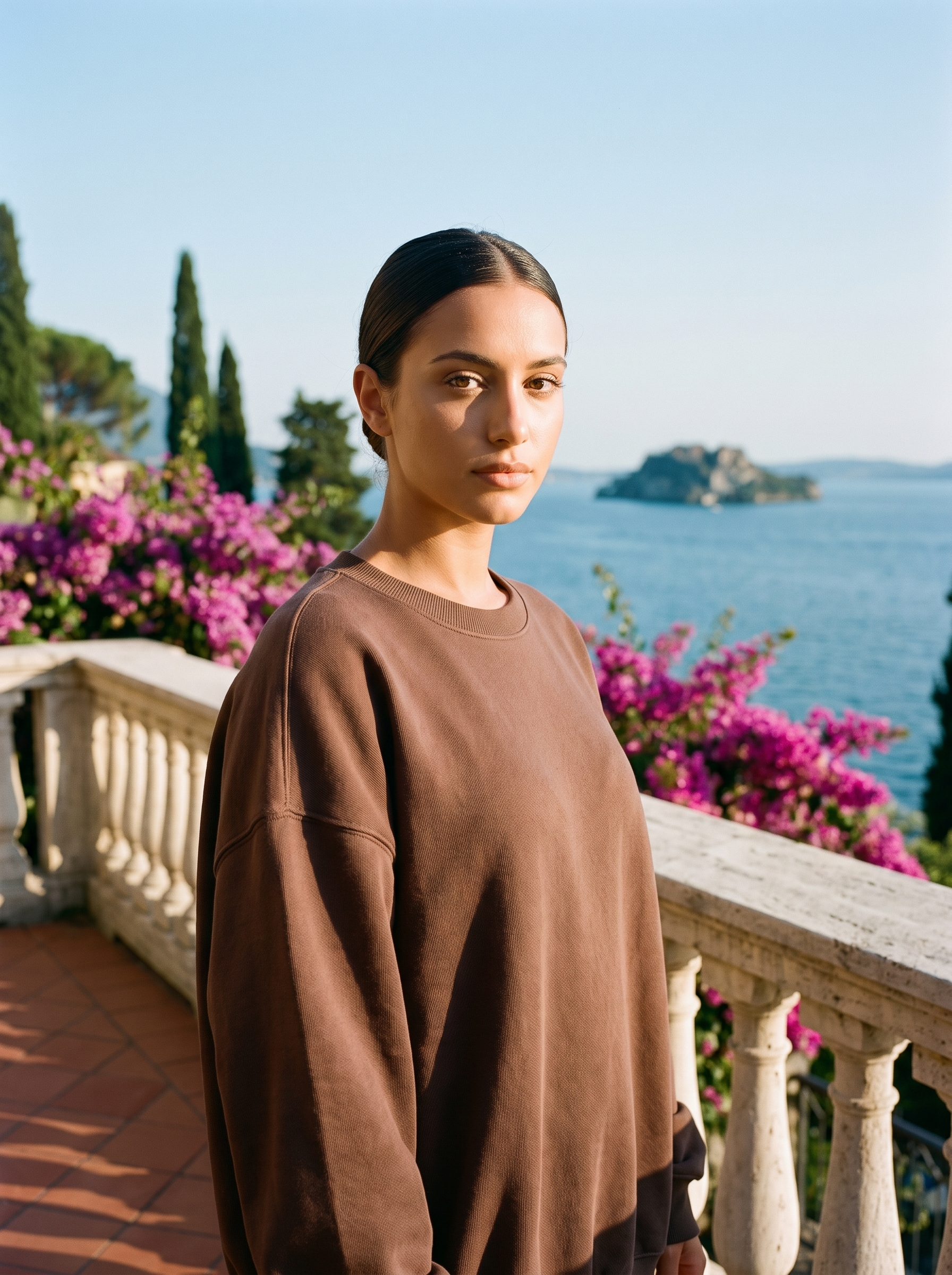 Woman wearing a cocoa brown oversized crew neck sweatshirt on a Lake Como terrace, old money style — Aveloire