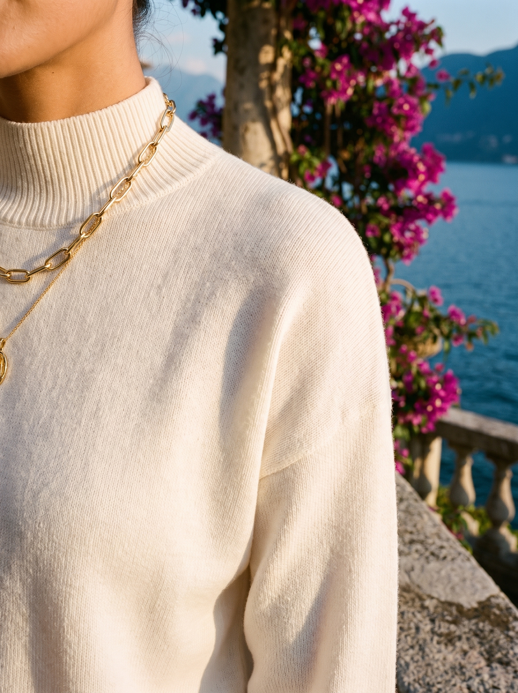 Close-up of the ribbed mock neck of an ivory knit jumper — Aveloire