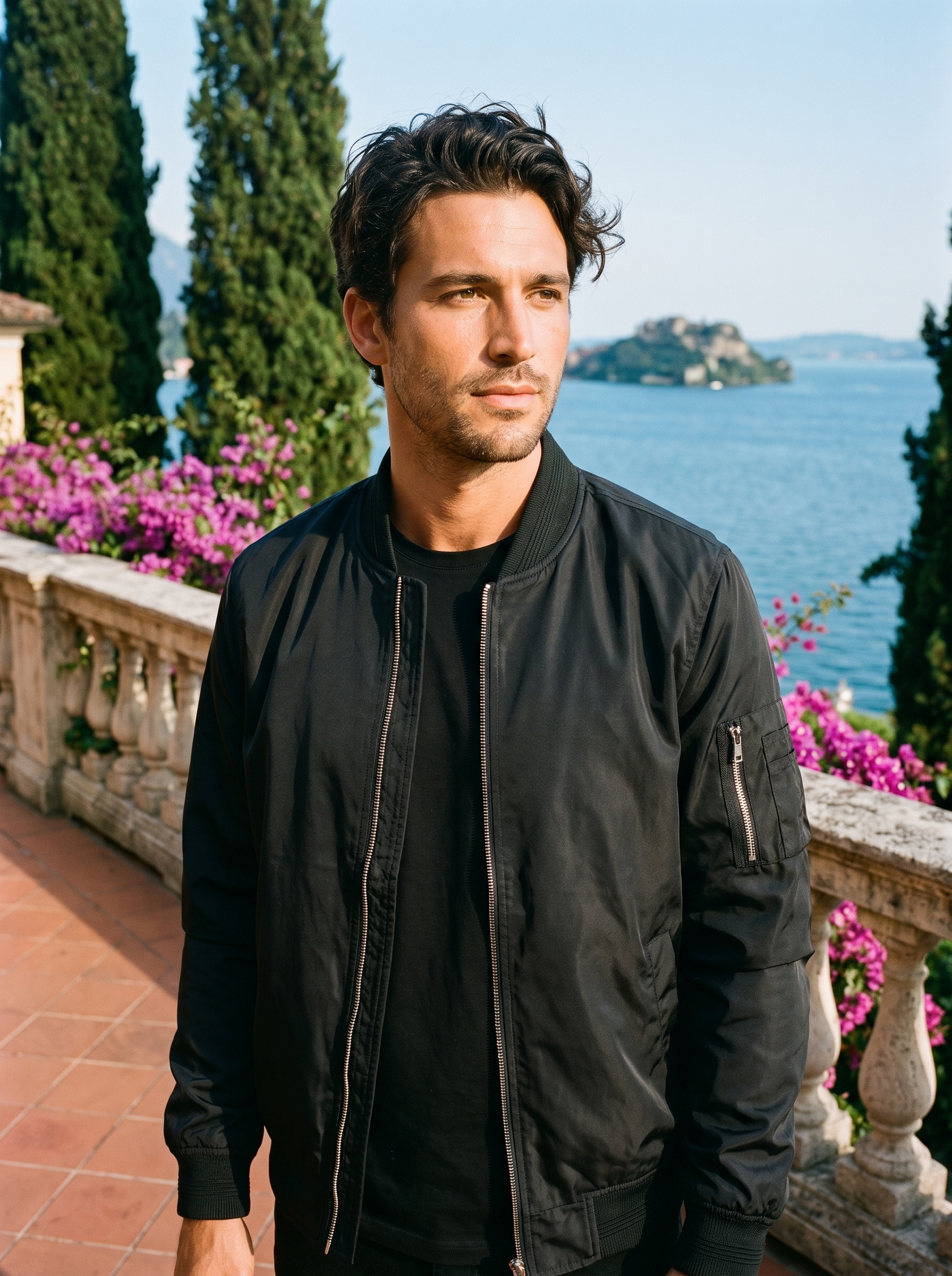 Man wearing black bomber jacket on a Lake Como terrace — Aveloire
