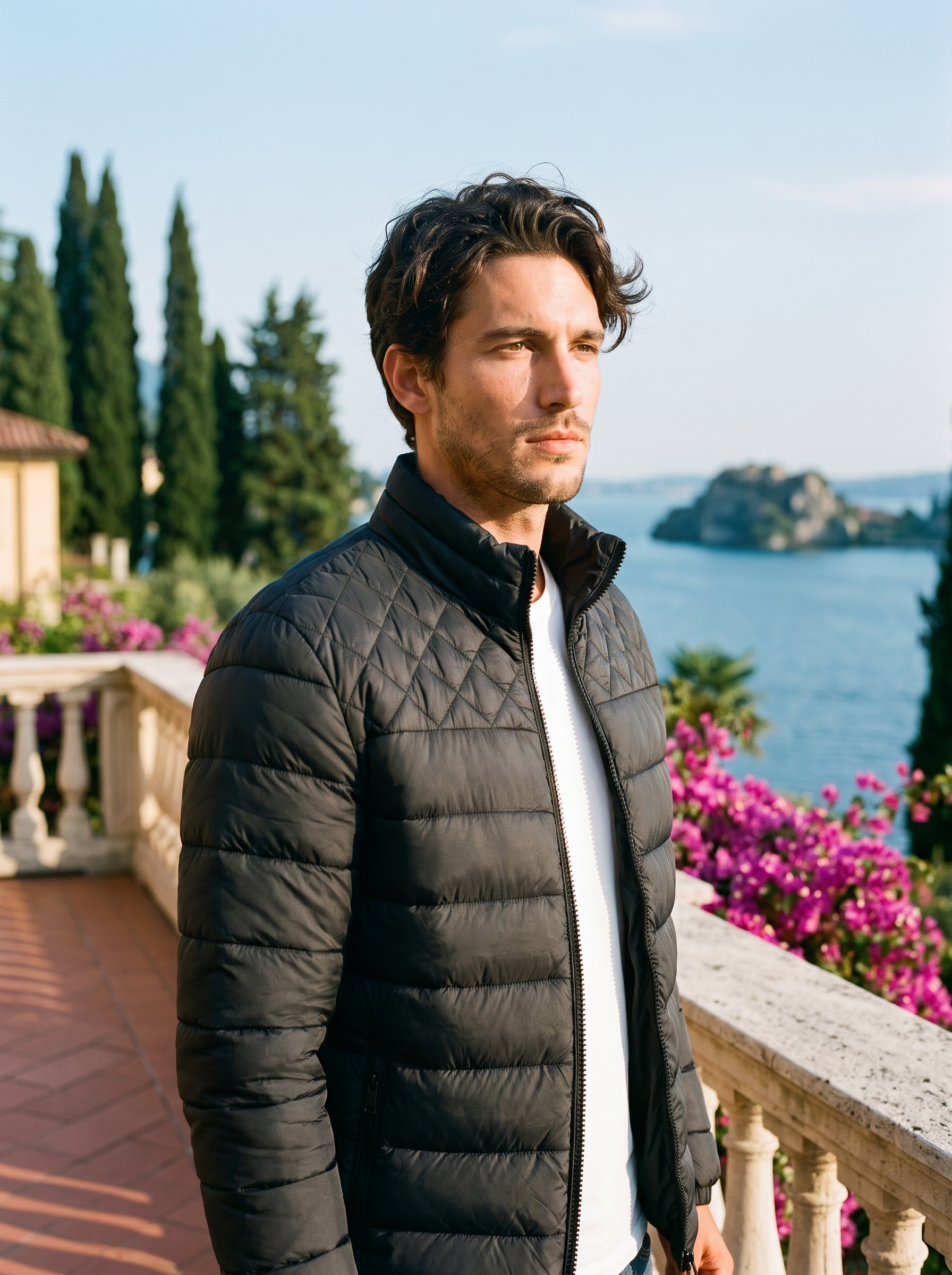 Man wearing black stand collar puffer jacket on a Lake Como terrace — Aveloire