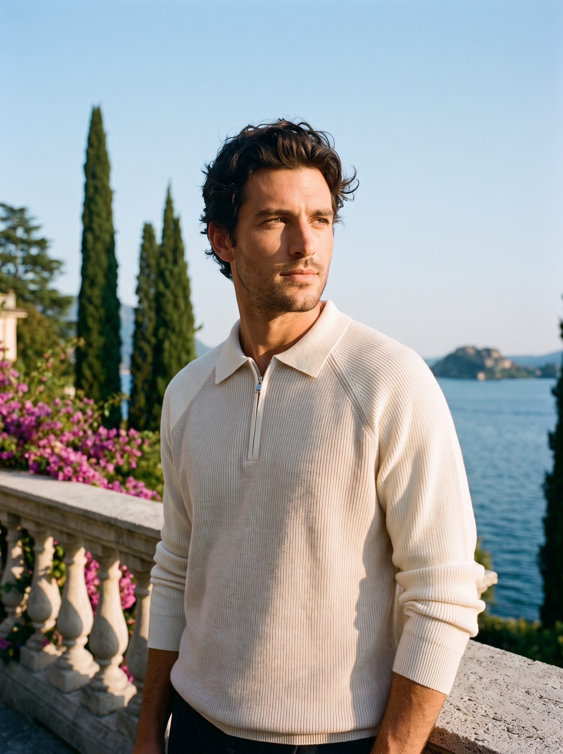 Man wearing a cream two-tone half-zip knit polo sweater on a terrace overlooking Lake Como, old money style — Aveloire