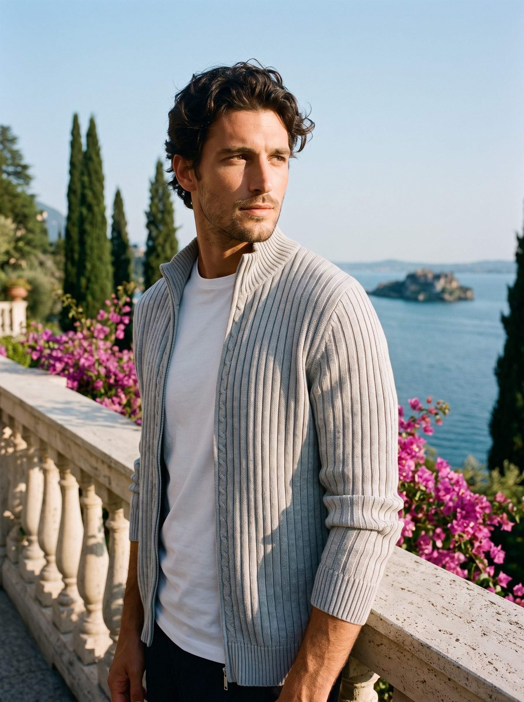 Man wearing a light gray ribbed cotton full-zip cardigan on a terrace overlooking Lake Como, old money style — Aveloire