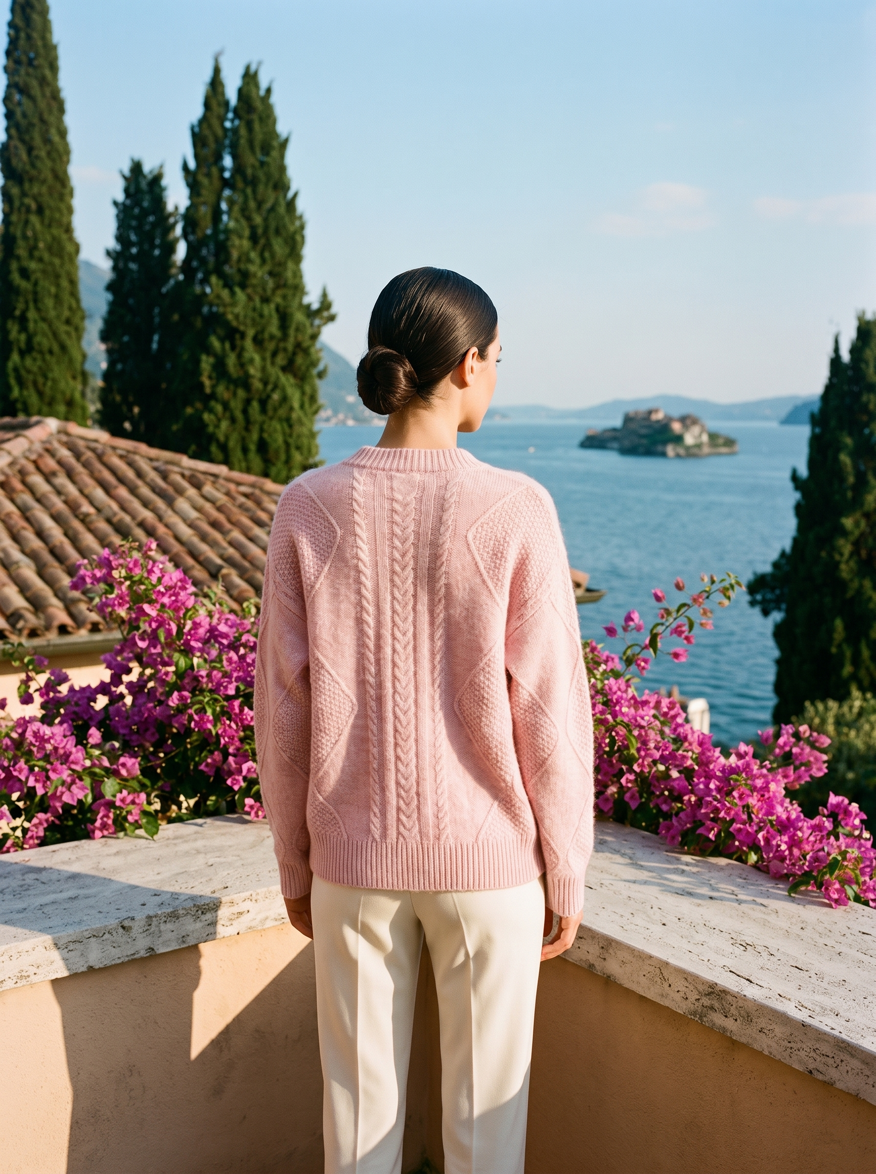 Pink cable-knit cardigan, full body back view on a Lake Como terrace — Aveloire