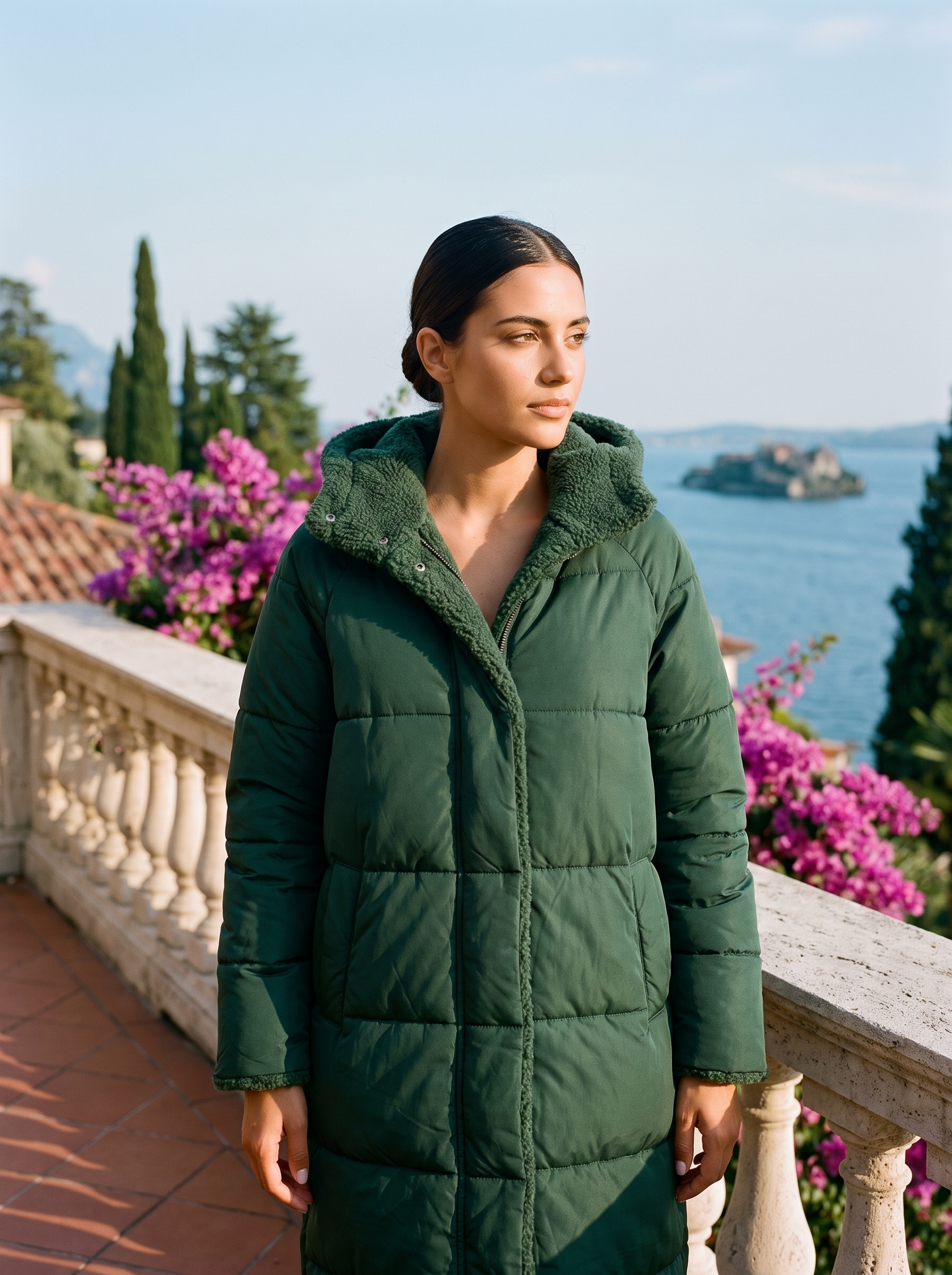 Woman wearing green puffer coat on a Lake Como terrace — Aveloire