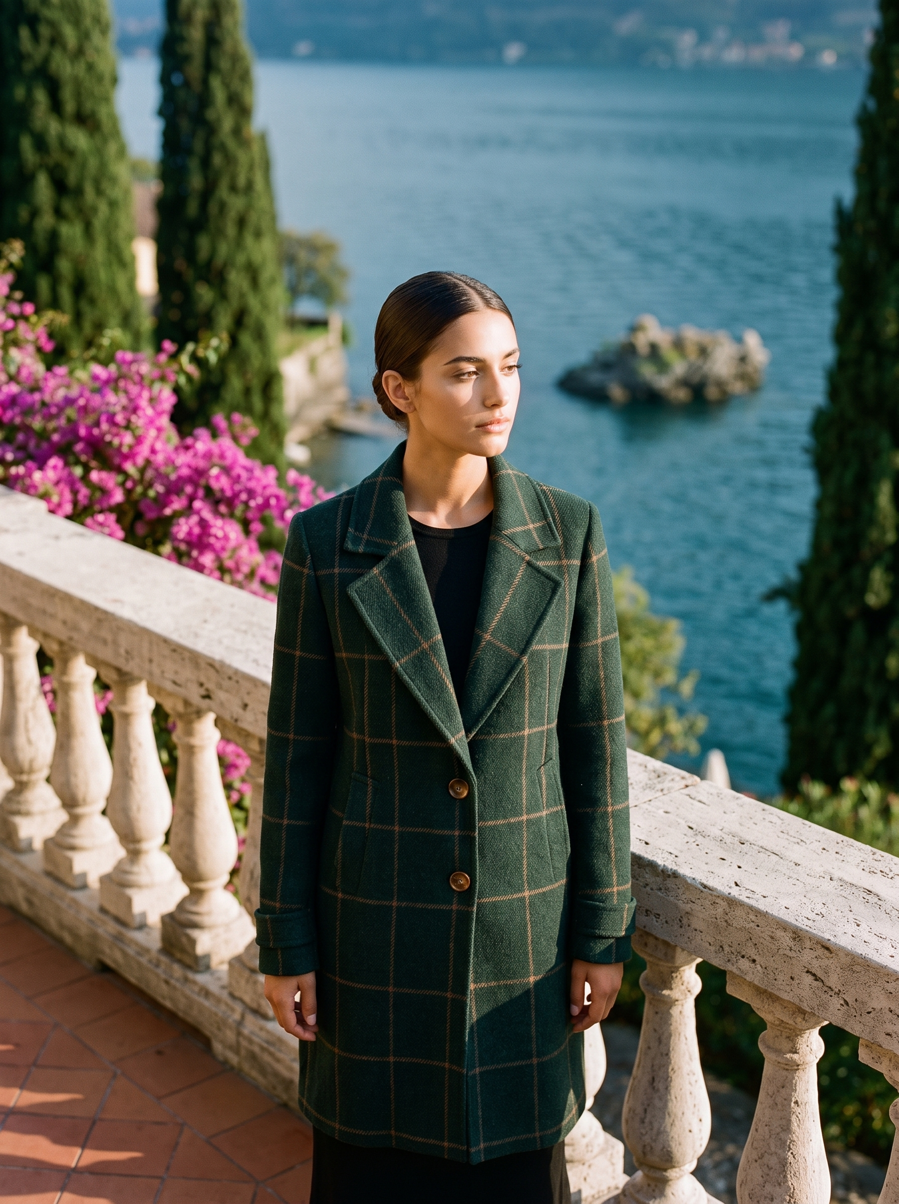 Woman wearing a green windowpane-check wool coat on a Lake Como terrace — Aveloire