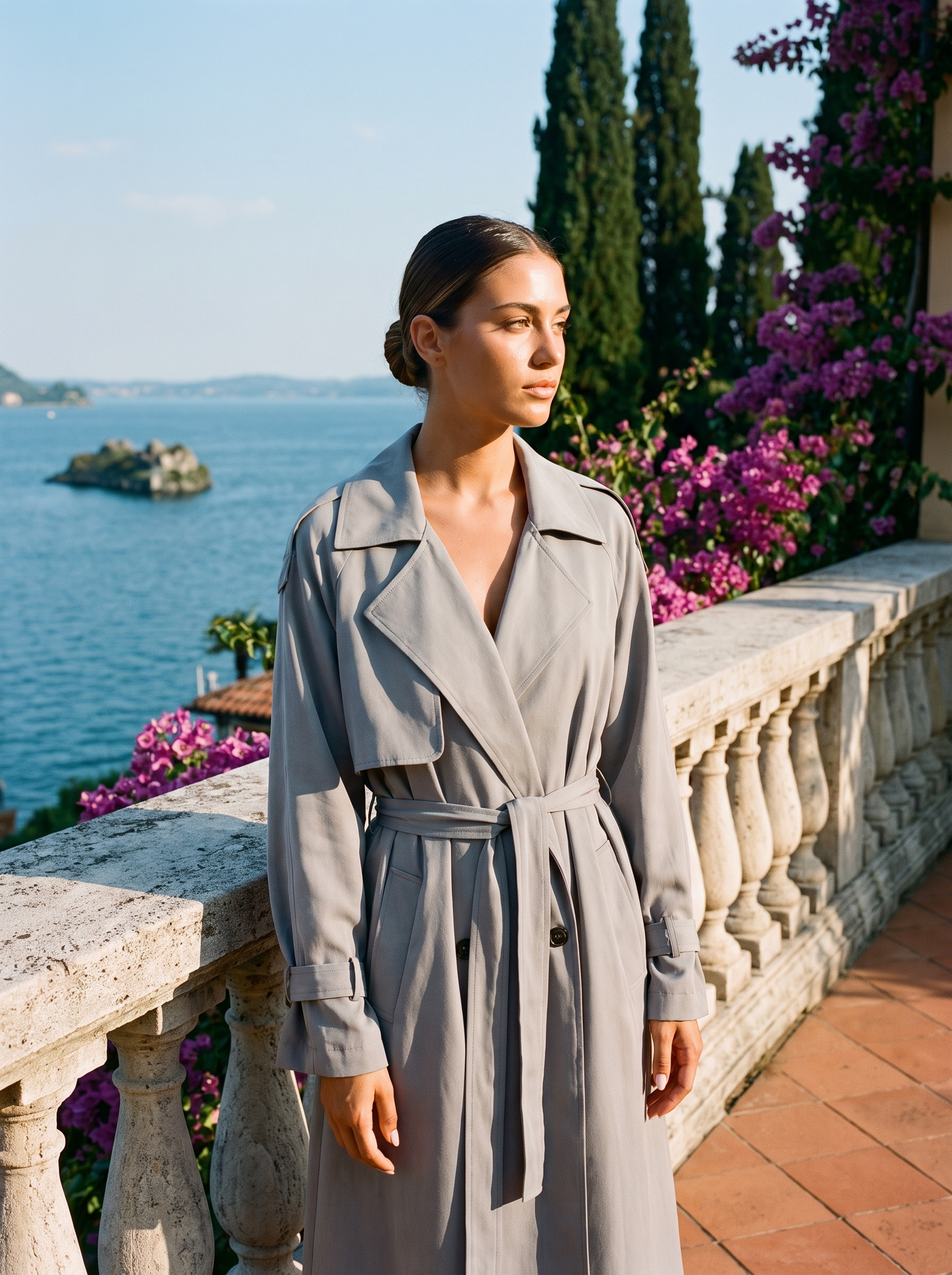 Woman wearing grey lightweight trench coat on a Lake Como terrace — Aveloire