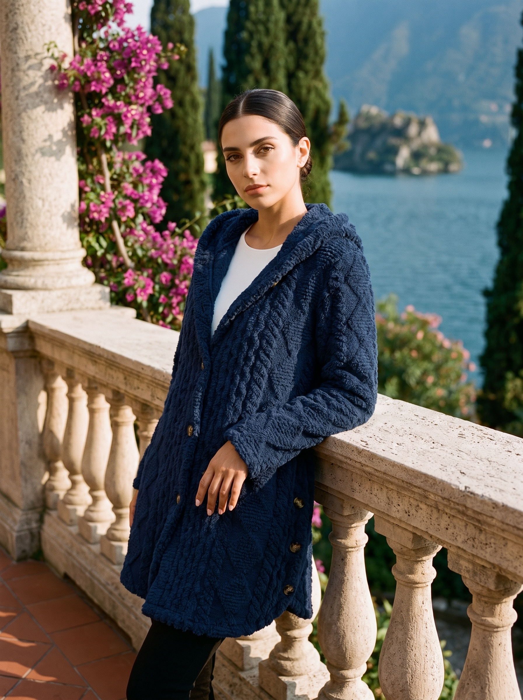 Woman wearing a navy plush hooded longline cardigan on a Lake Como terrace — Aveloire