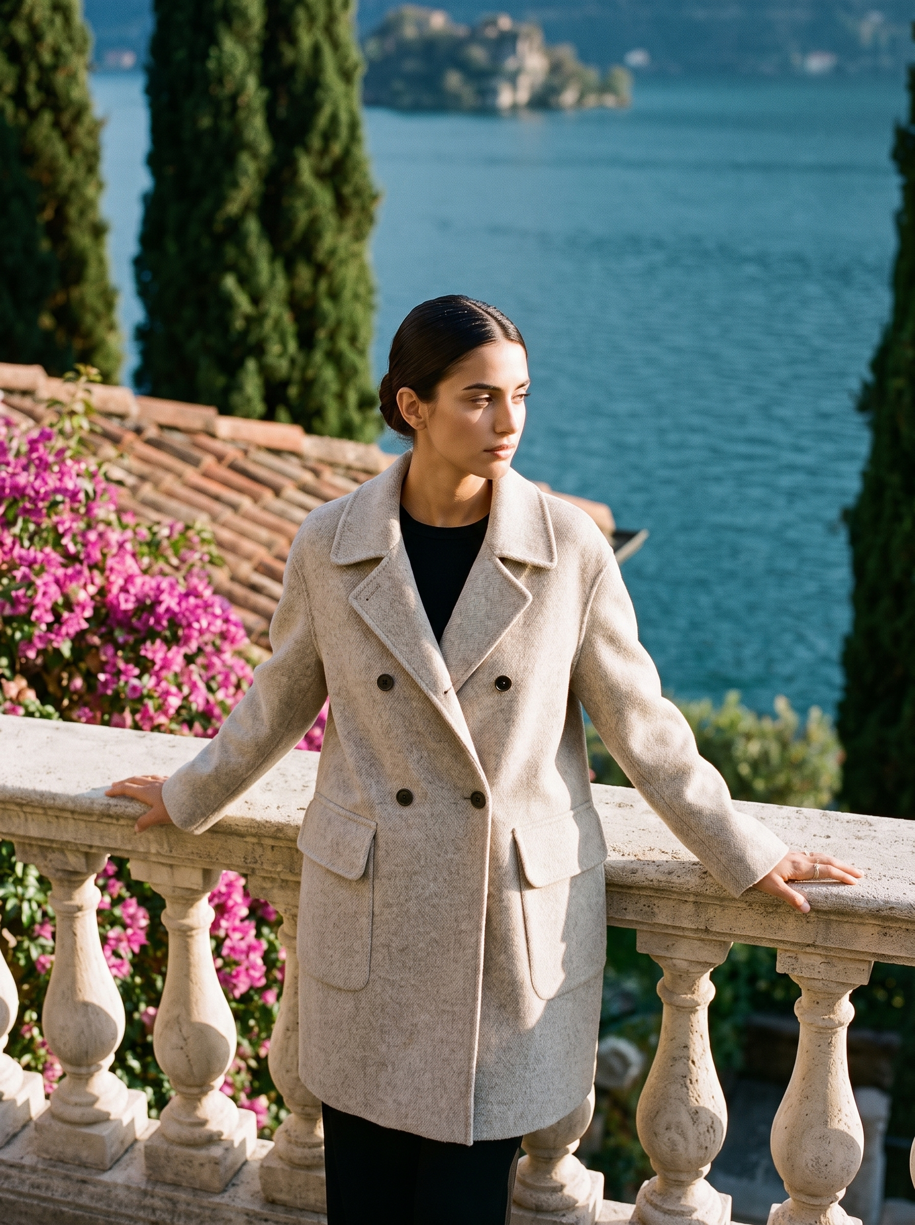Woman wearing an oatmeal double-breasted wool coat on a Lake Como terrace — Aveloire