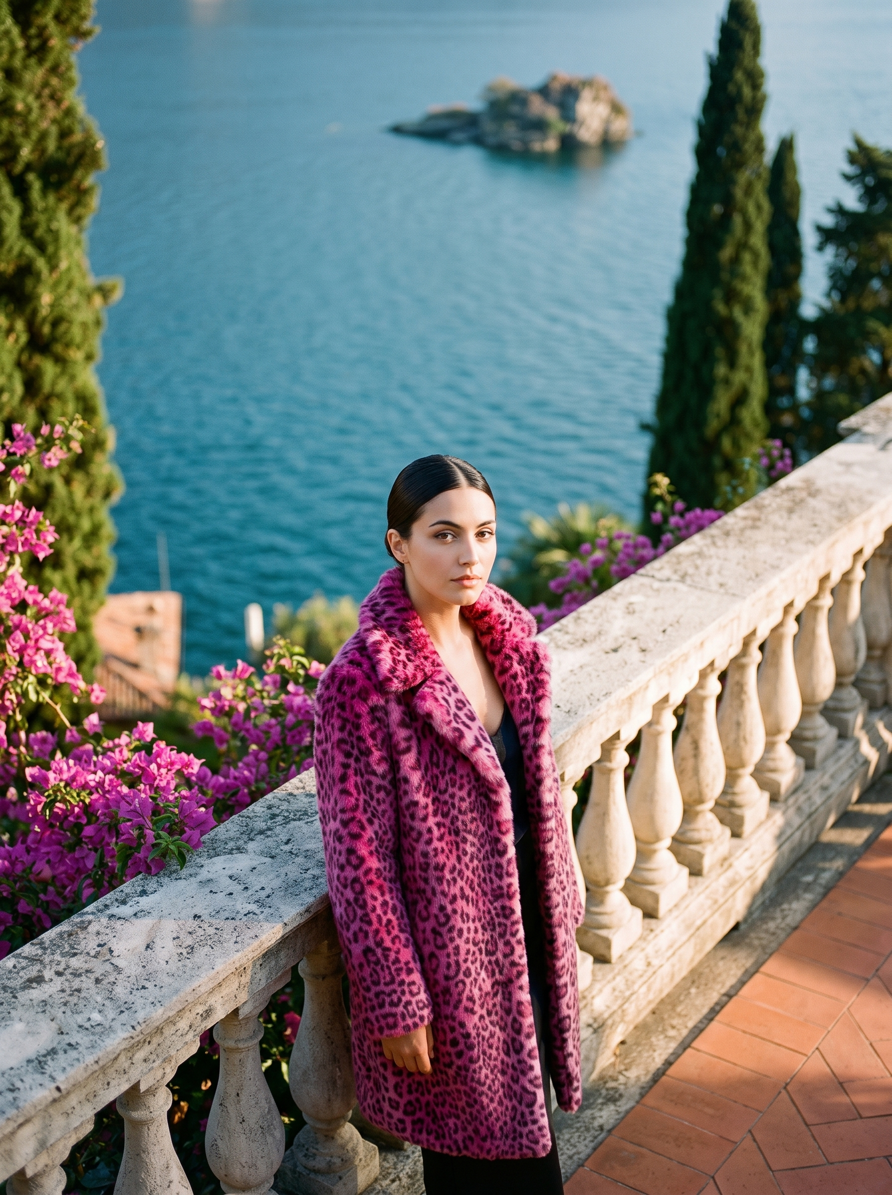 Woman wearing magenta pink leopard print faux fur coat on a Lake Como terrace