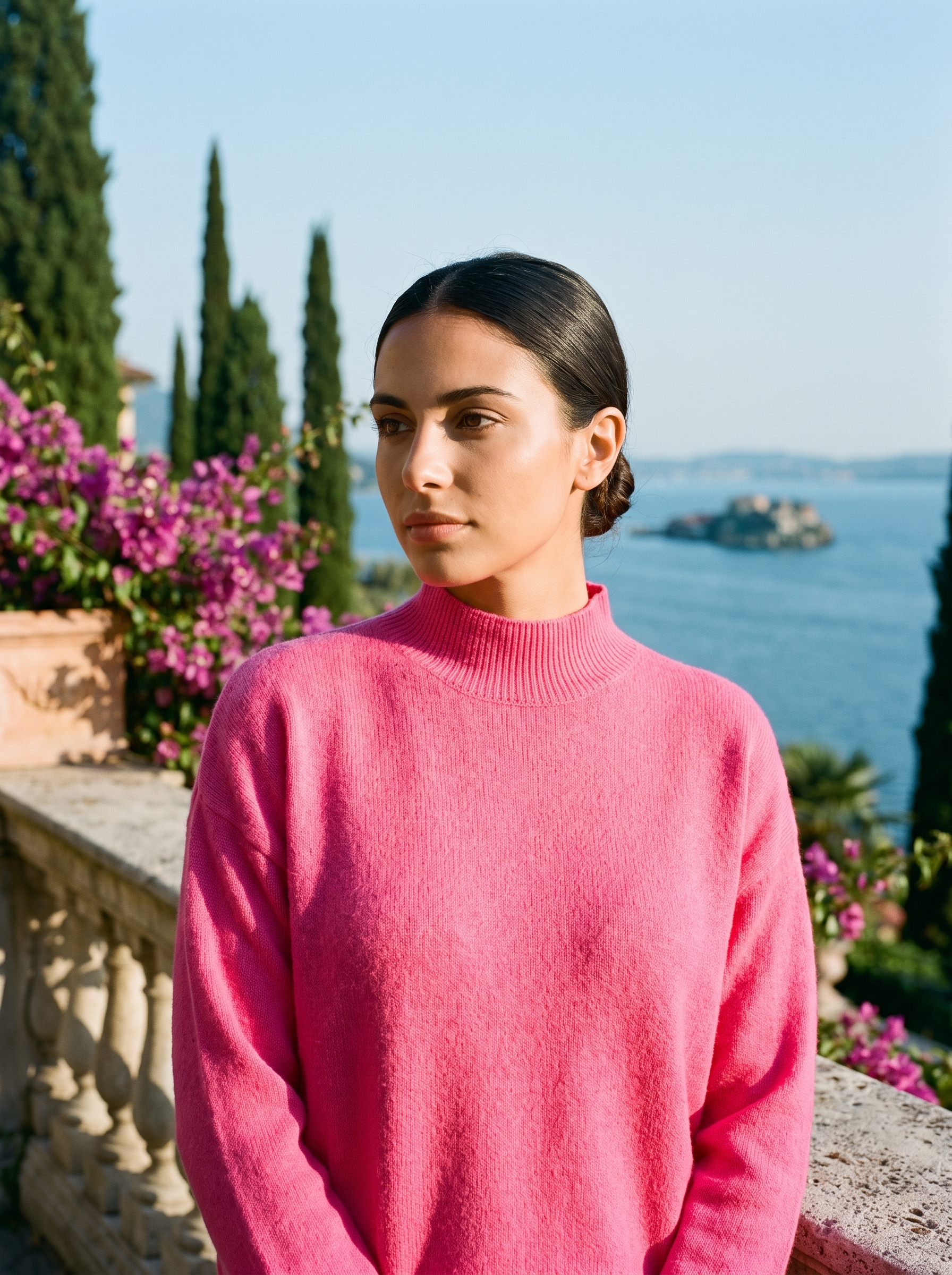 Woman wearing a rose-pink mock-neck jumper on a terrace overlooking Lake Como — Aveloire
