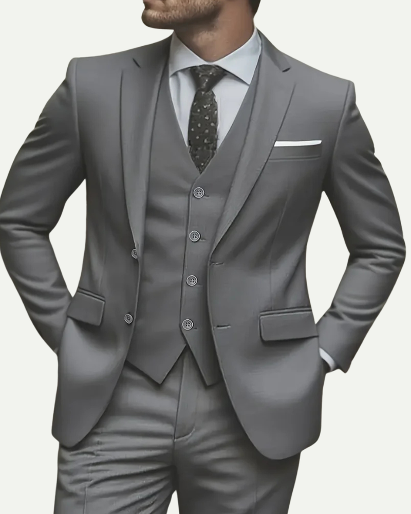 Close up male model wearing grey tuxedo suit vest and tie formal outfit detail
