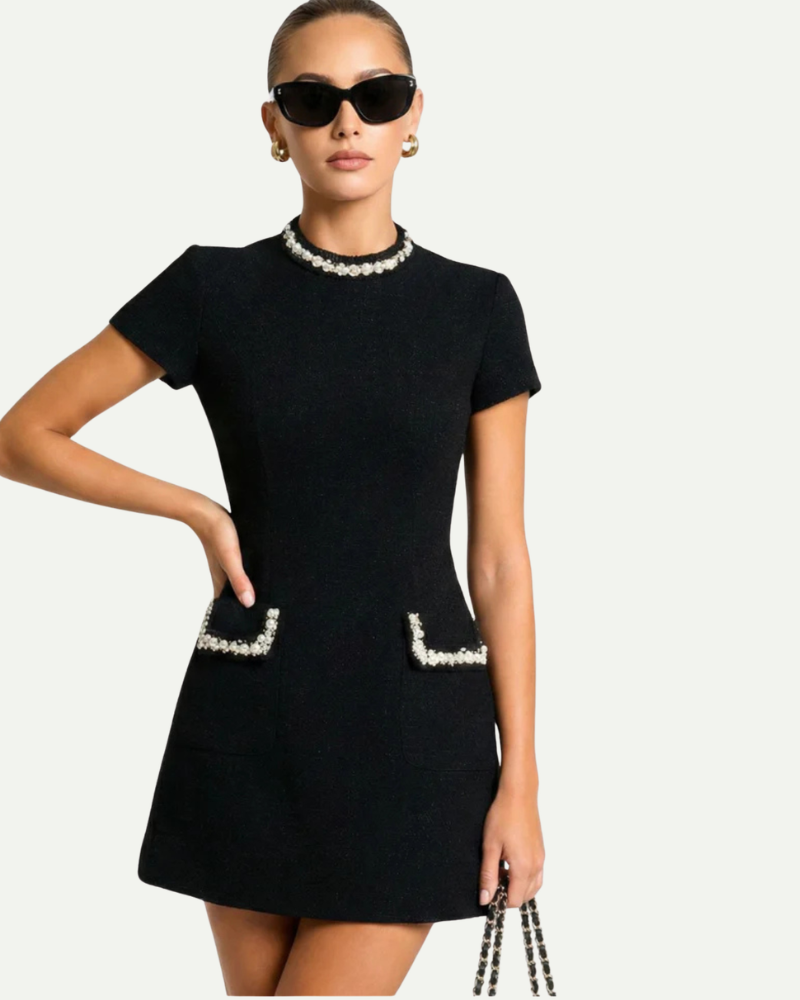 Female model wearing black tweed mini dress short sleeve fitted elegant outfit
