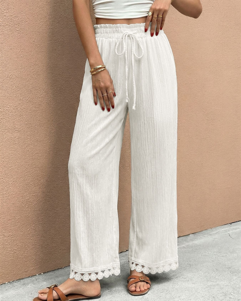 model wearing white wide leg trousers high waist drawstring front view relaxed fit
