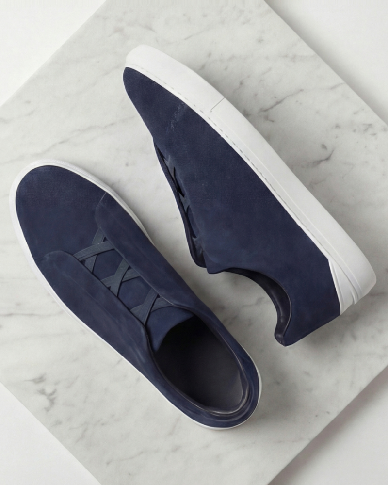Men navy suede slip on sneakers top angle view minimalist casual footwear
