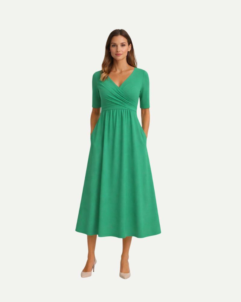 Female model wearing green V-neck midi dress empire waist summer outfit
