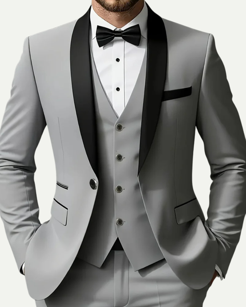 Close up male model wearing grey tuxedo suit satin shawl lapel vest and bow tie detail
