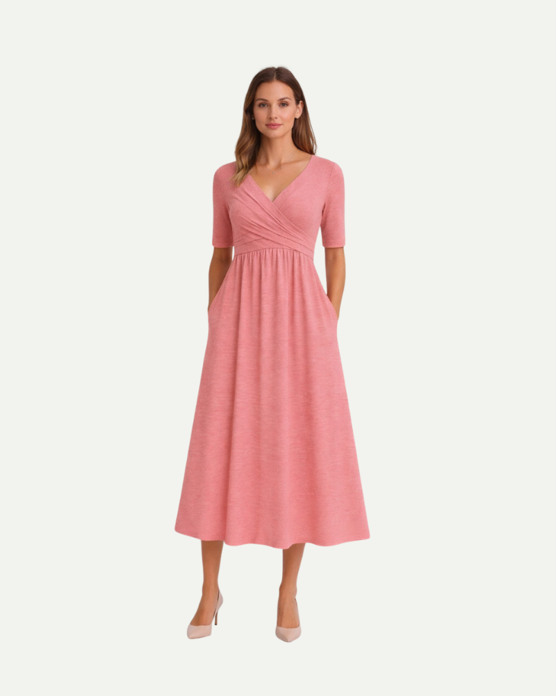 Female model wearing pink V-neck midi dress short sleeve soft flowing silhouette
