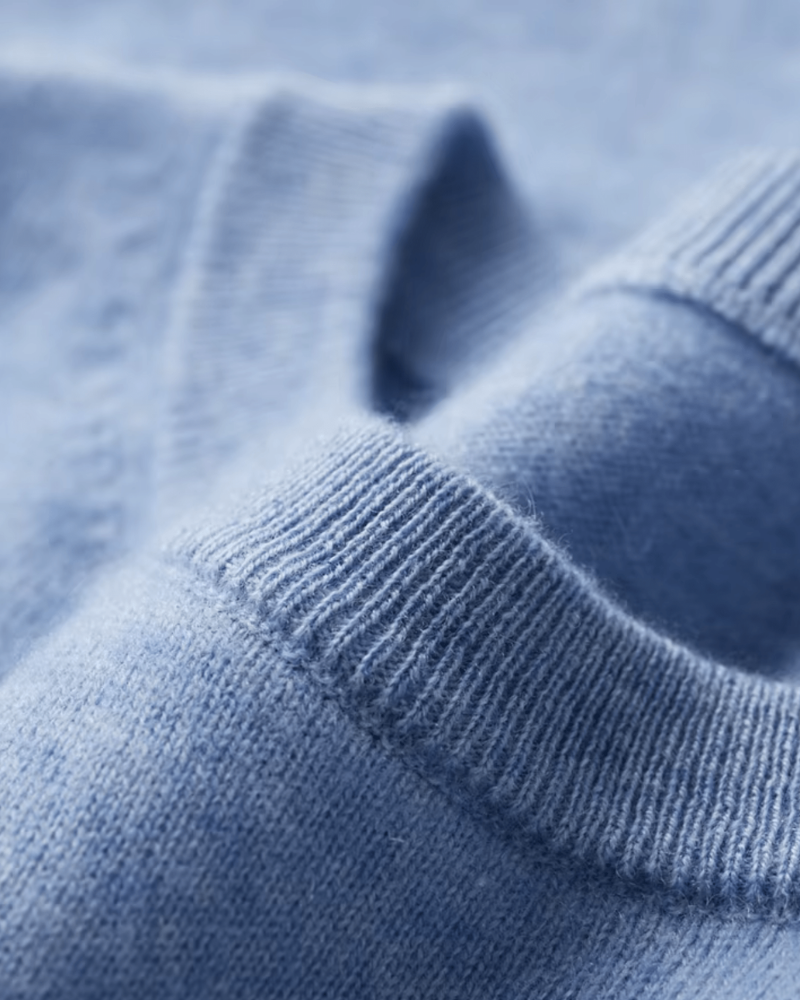 Light blue cashmere wool knit T shirt fabric detail soft luxury texture close up
