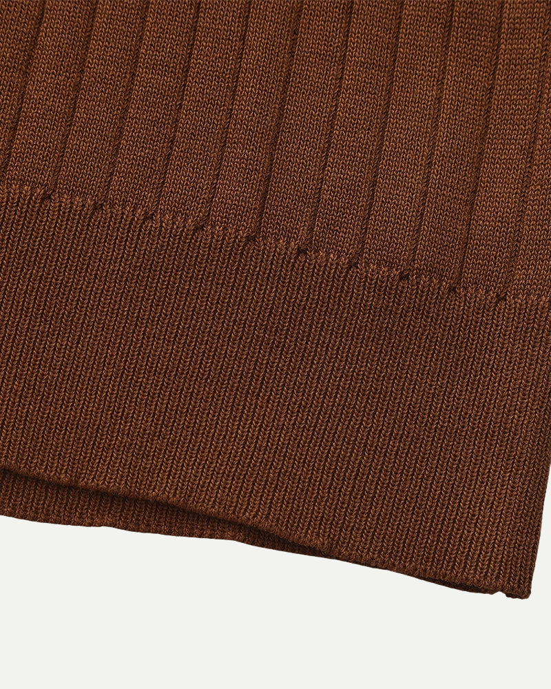 Close-up of a brown knitted fabric on a white background
