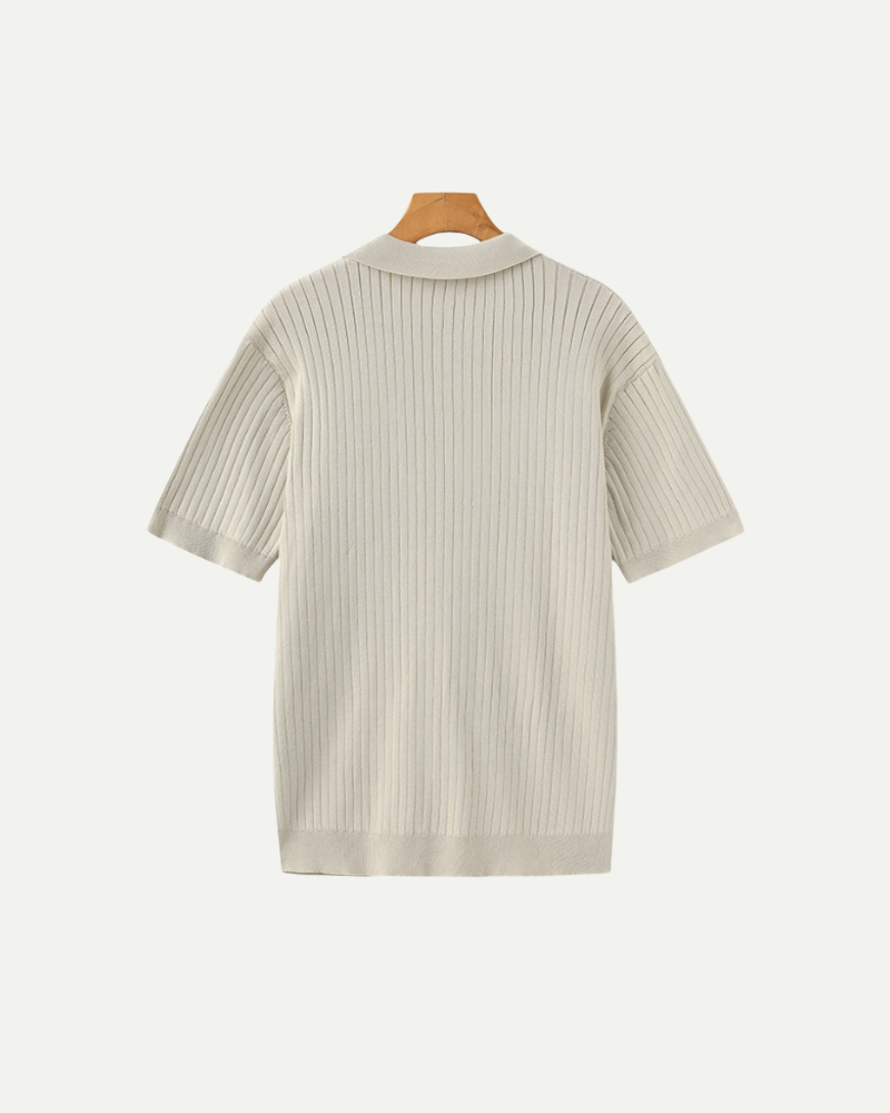 Beige ribbed knit shirt on a hanger against a white background