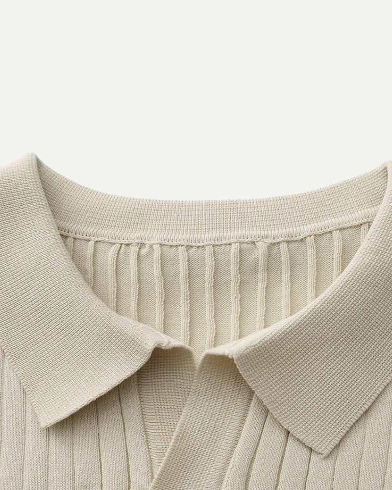 Close-up of a beige ribbed polo with a collar on a light background