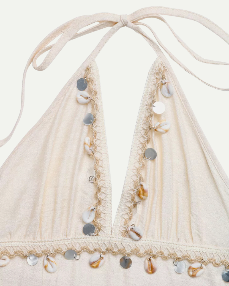 Halter dress detail beige neckline straps beads embroidery close up

